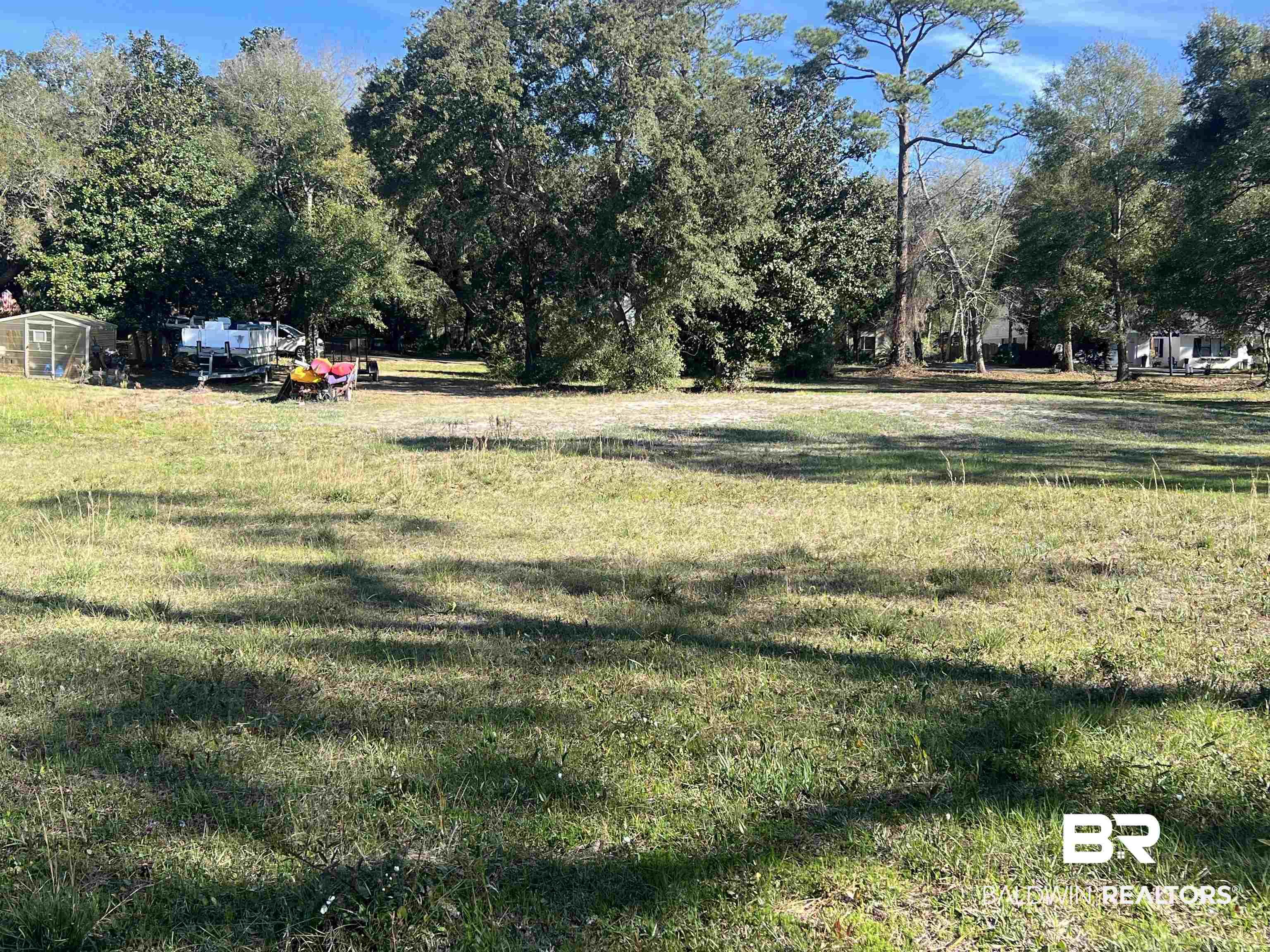 Image 2: View of green lawn featuring view of wooded area