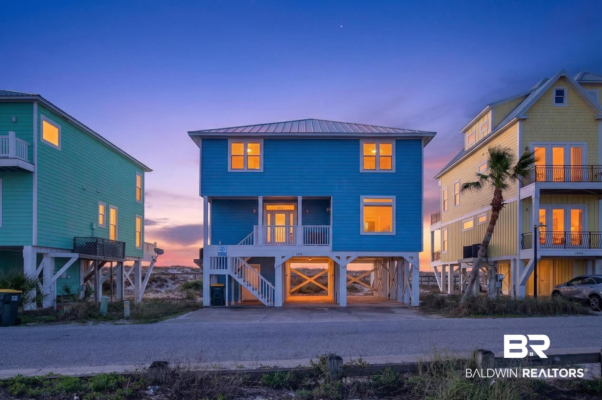 Image 3: Coastal inspired home featuring a metal roof, a carport, and a balcony