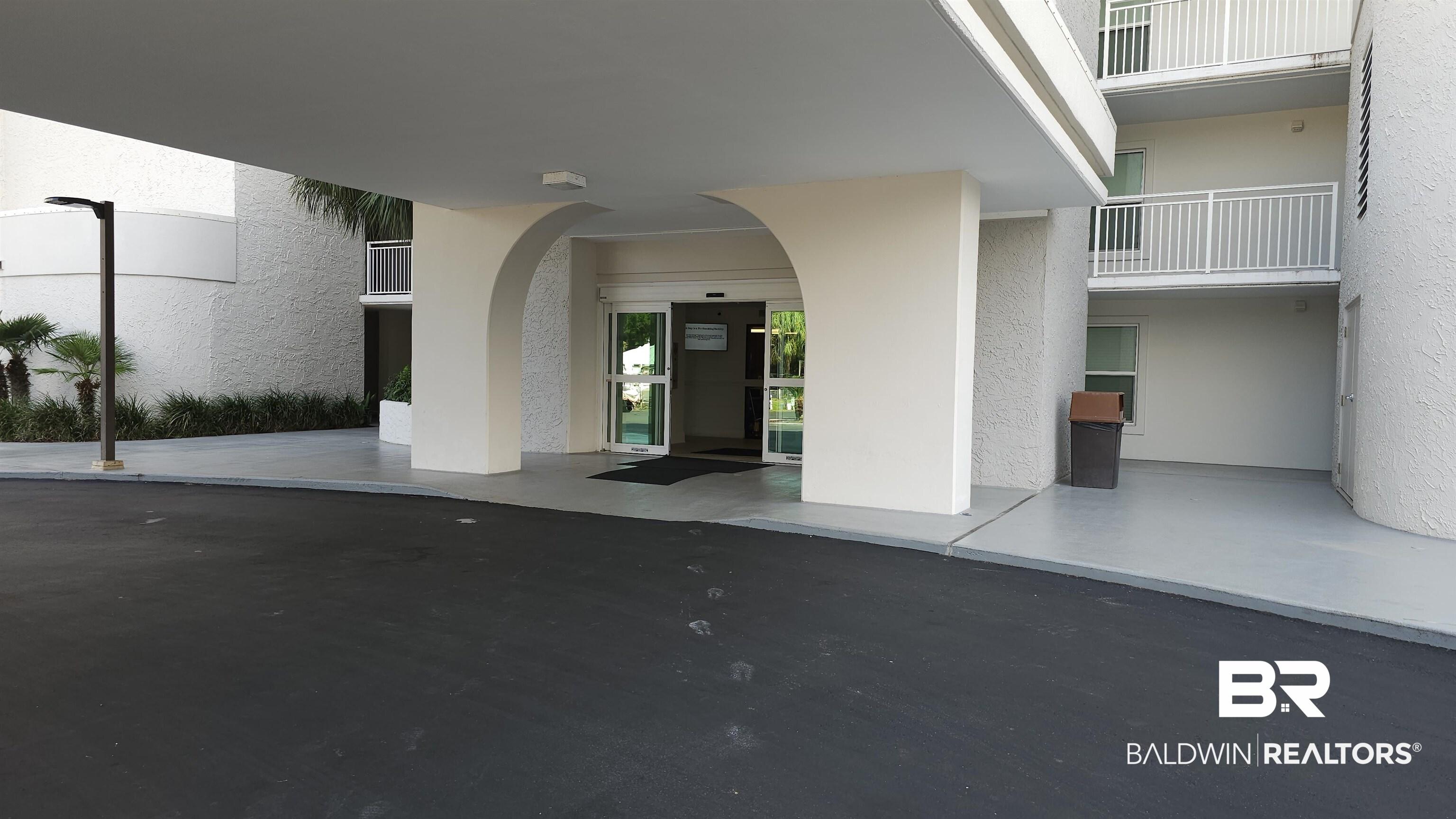 Image 2: Doorway to property featuring stucco siding