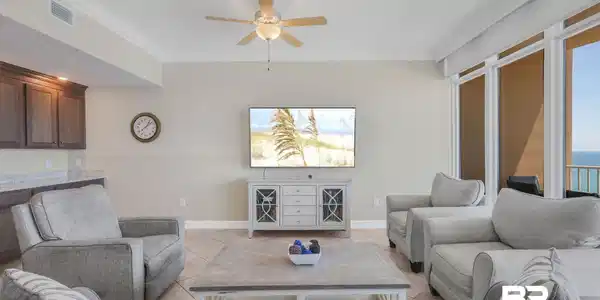 Image 4: Living room with ornamental molding, light tile patterned flooring, and ceiling fan