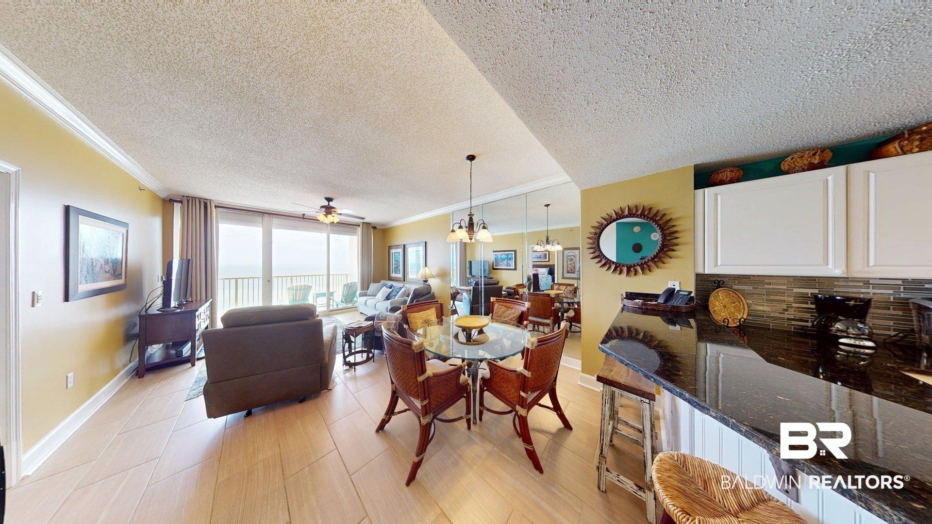 Image 2: Dining space with a textured ceiling, floor to ceiling windows, hanging lights, ornamental molding, and ceiling fan