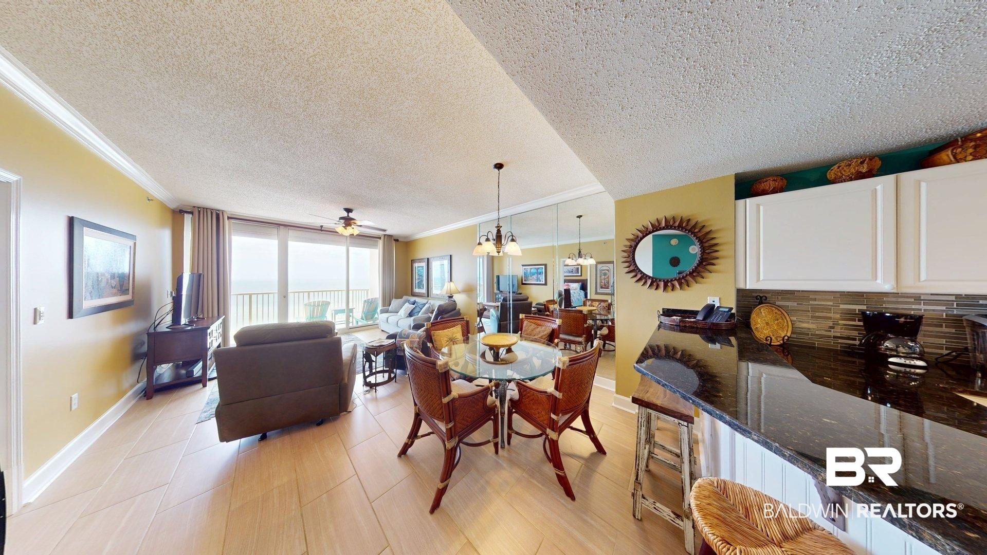 Image 3: Dining area with a textured ceiling, hanging lights, ornamental molding, expansive windows, and a ceiling fan