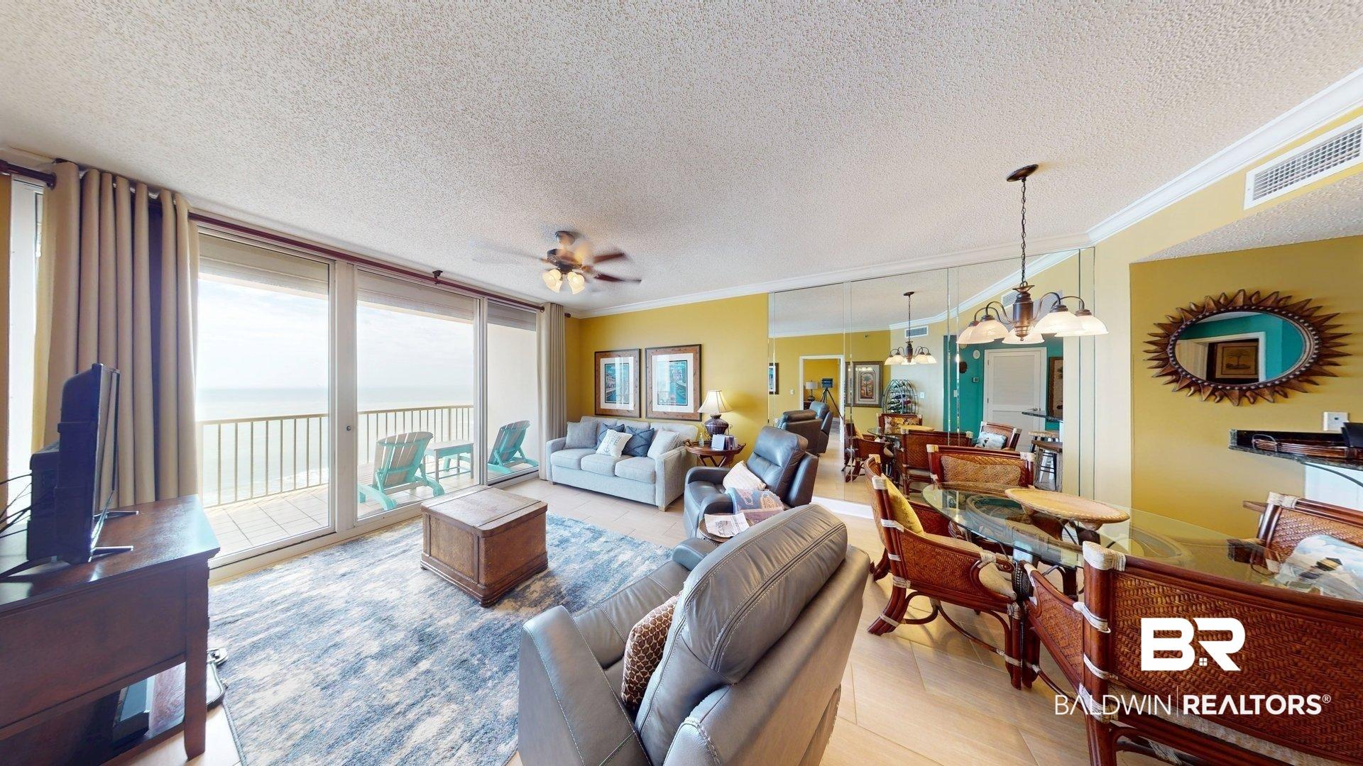Image 4: Living area featuring a ceiling fan, a textured ceiling, ornamental molding, and hanging lights