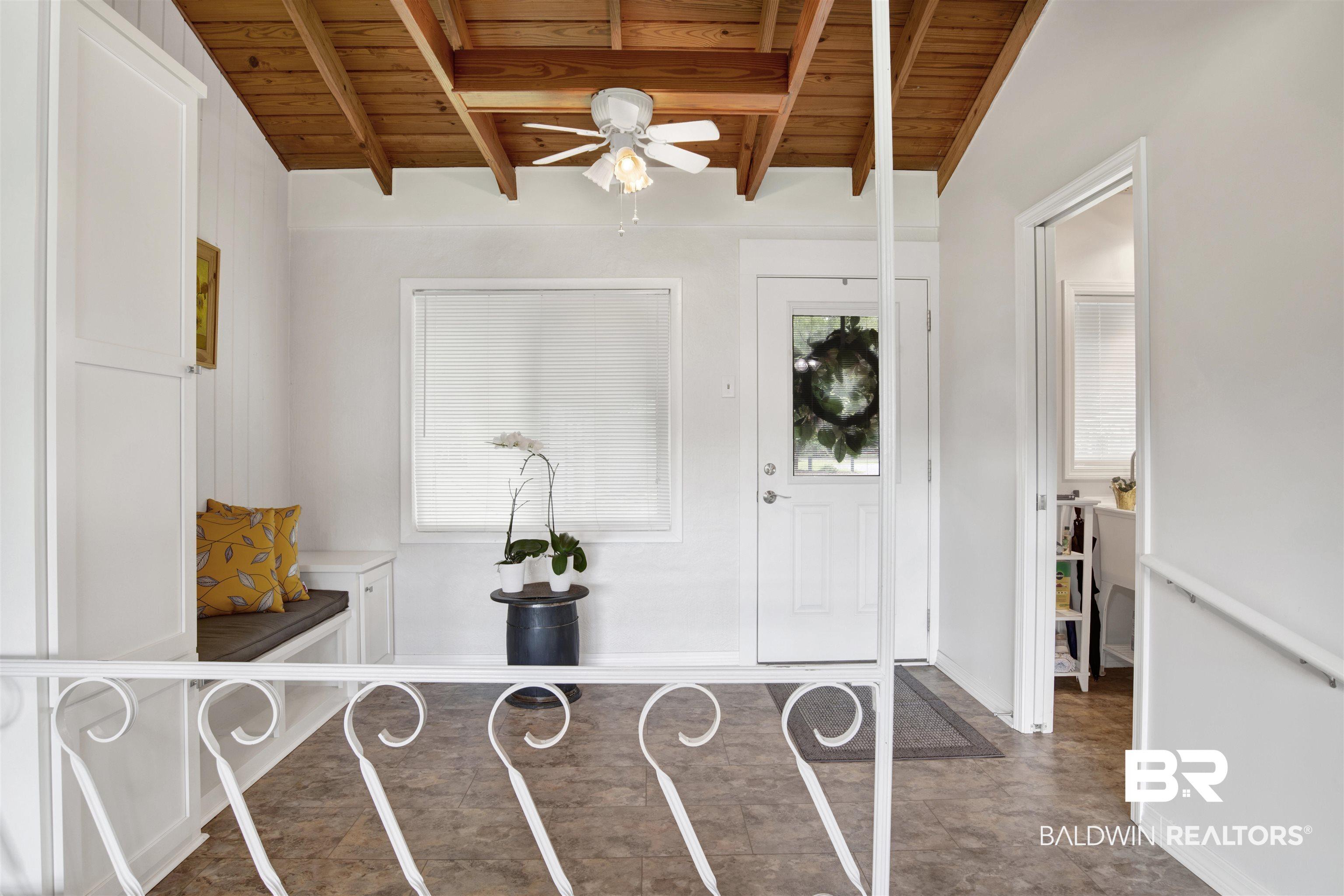 Image 2: Foyer with a wooden ceiling with exposed beams and a ceiling fan