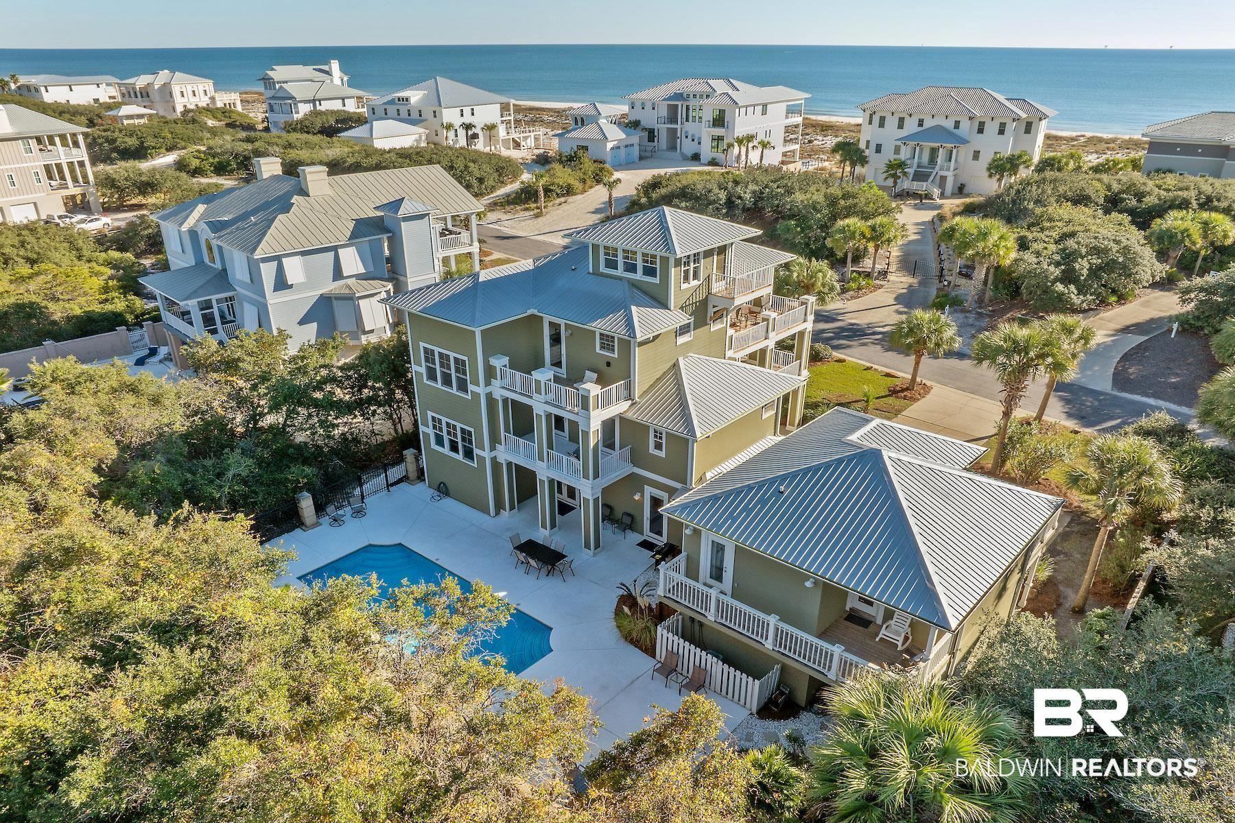 Image 2: Aerial view of residential area with a nearby body of water