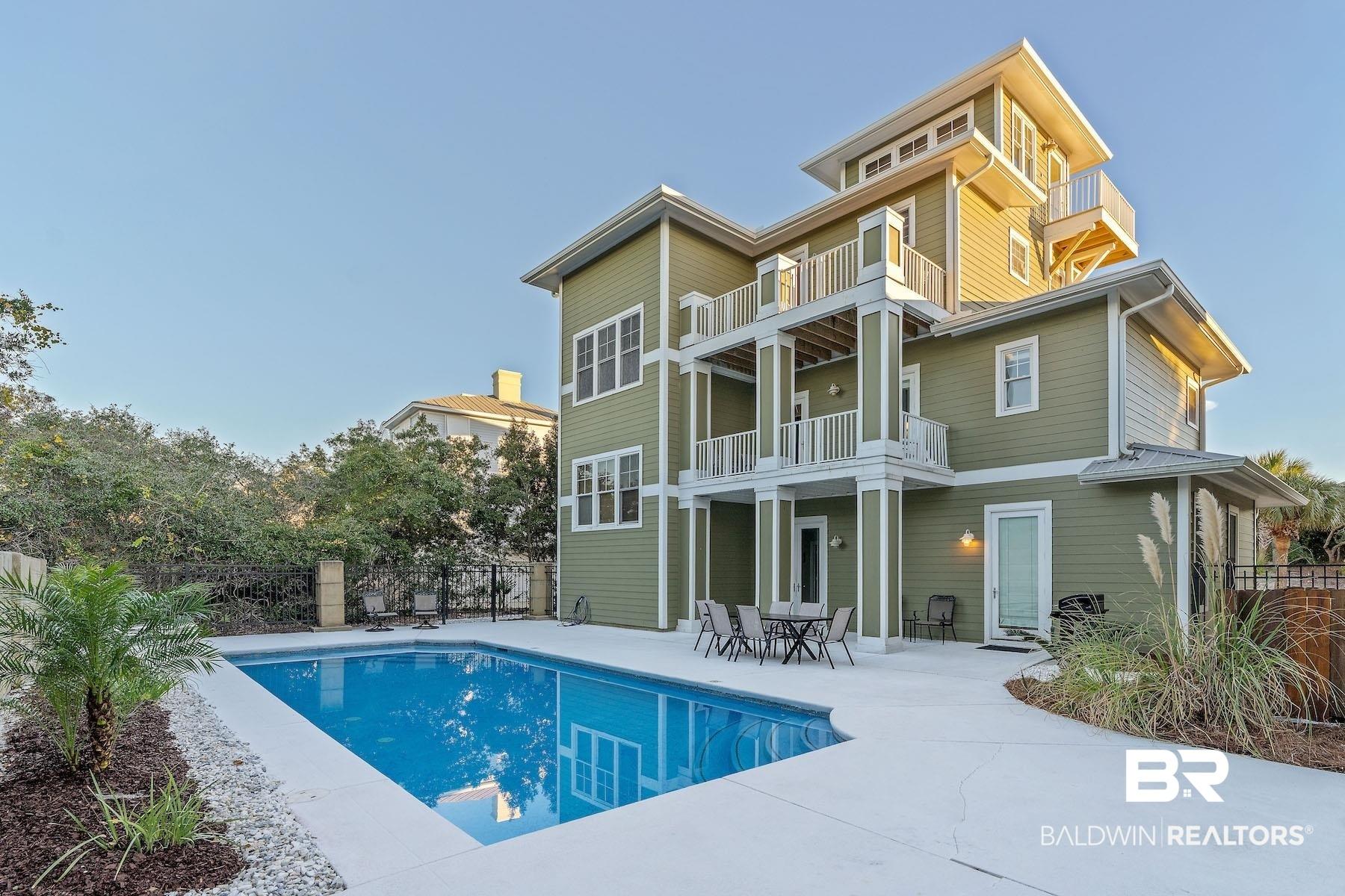 Image 3: Rear view of house with a patio and a balcony