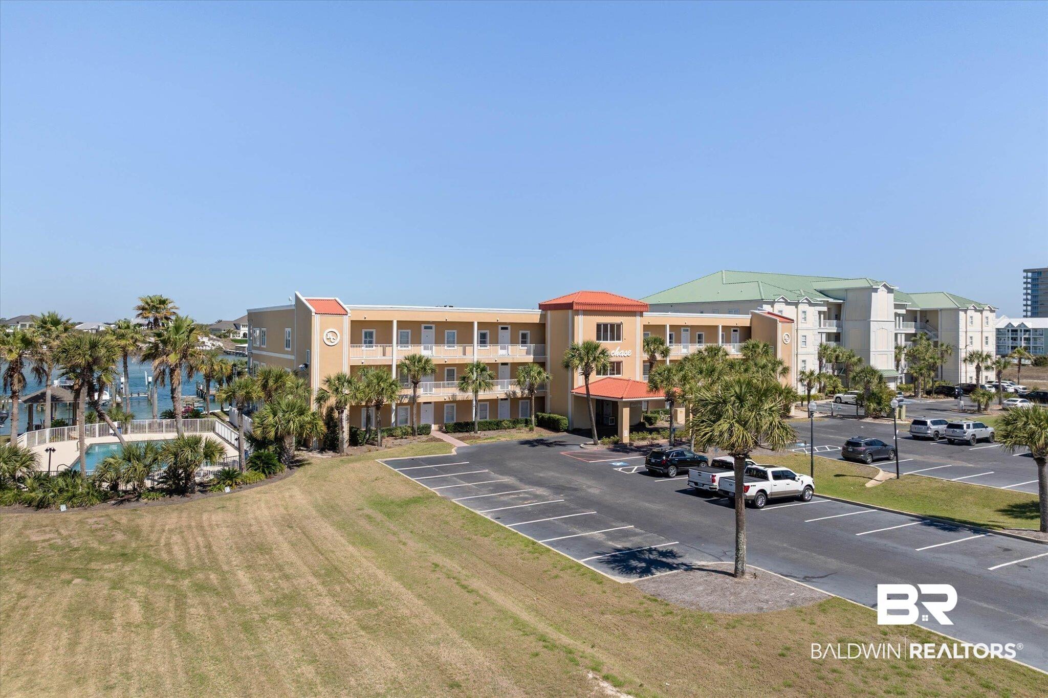 Image 2: View of apartment building / complex with uncovered parking