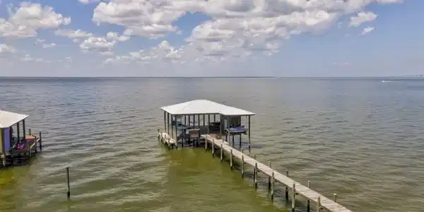 Image 2: Dock area with boat lift and a water view