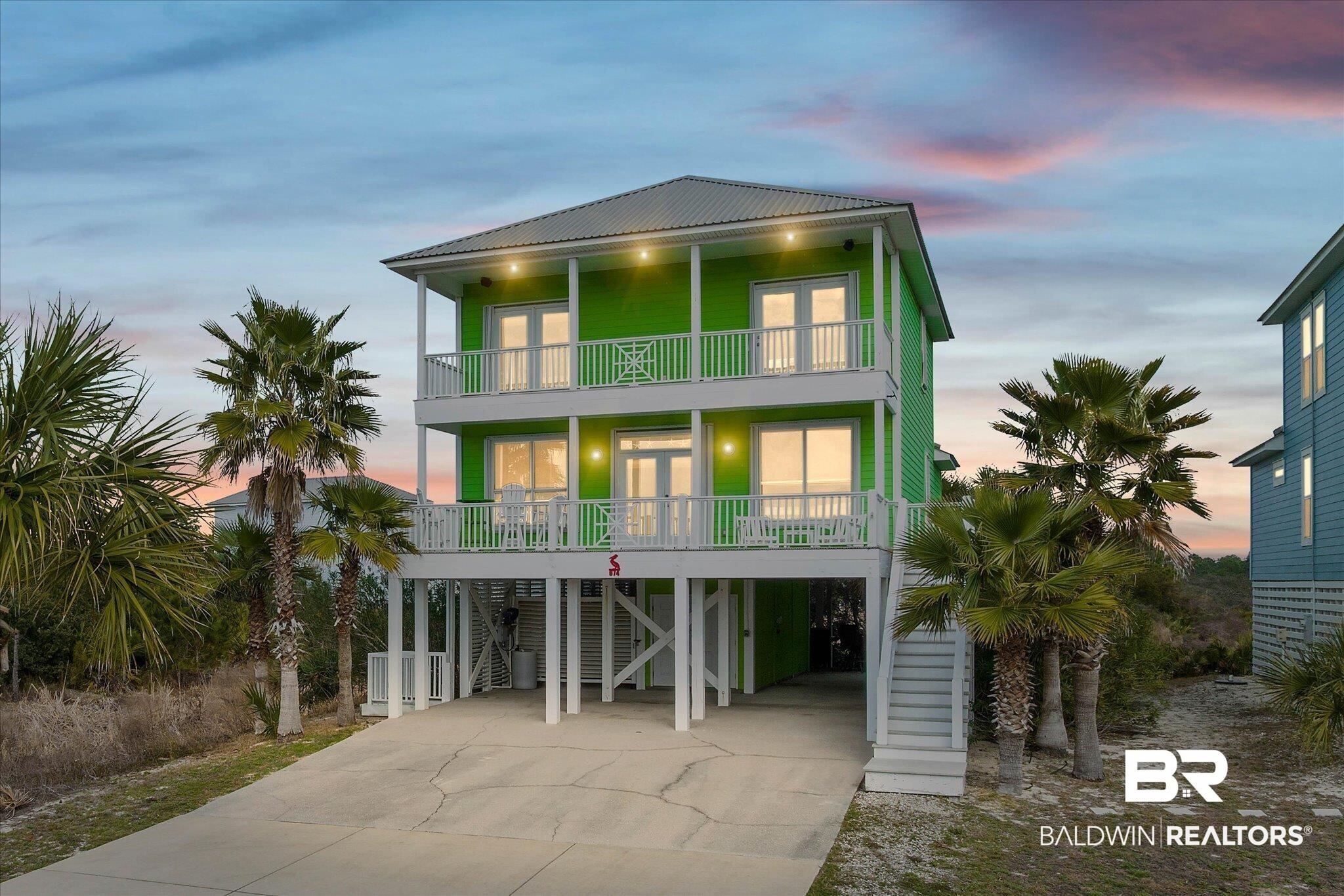 Image 2: Beach home featuring french doors, a carport, and driveway