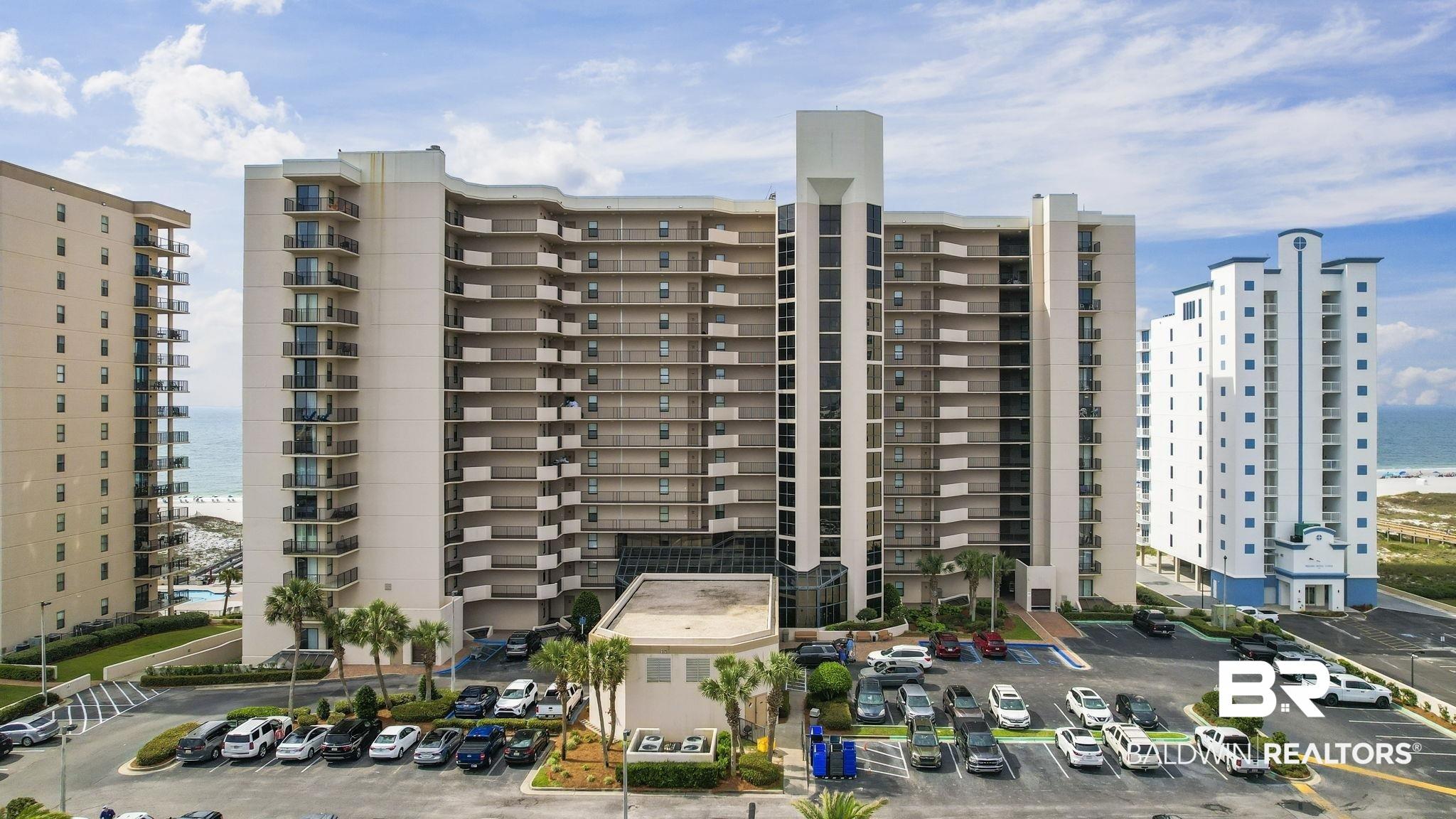 Image 2: View of apartment building / complex featuring a water view and uncovered parking