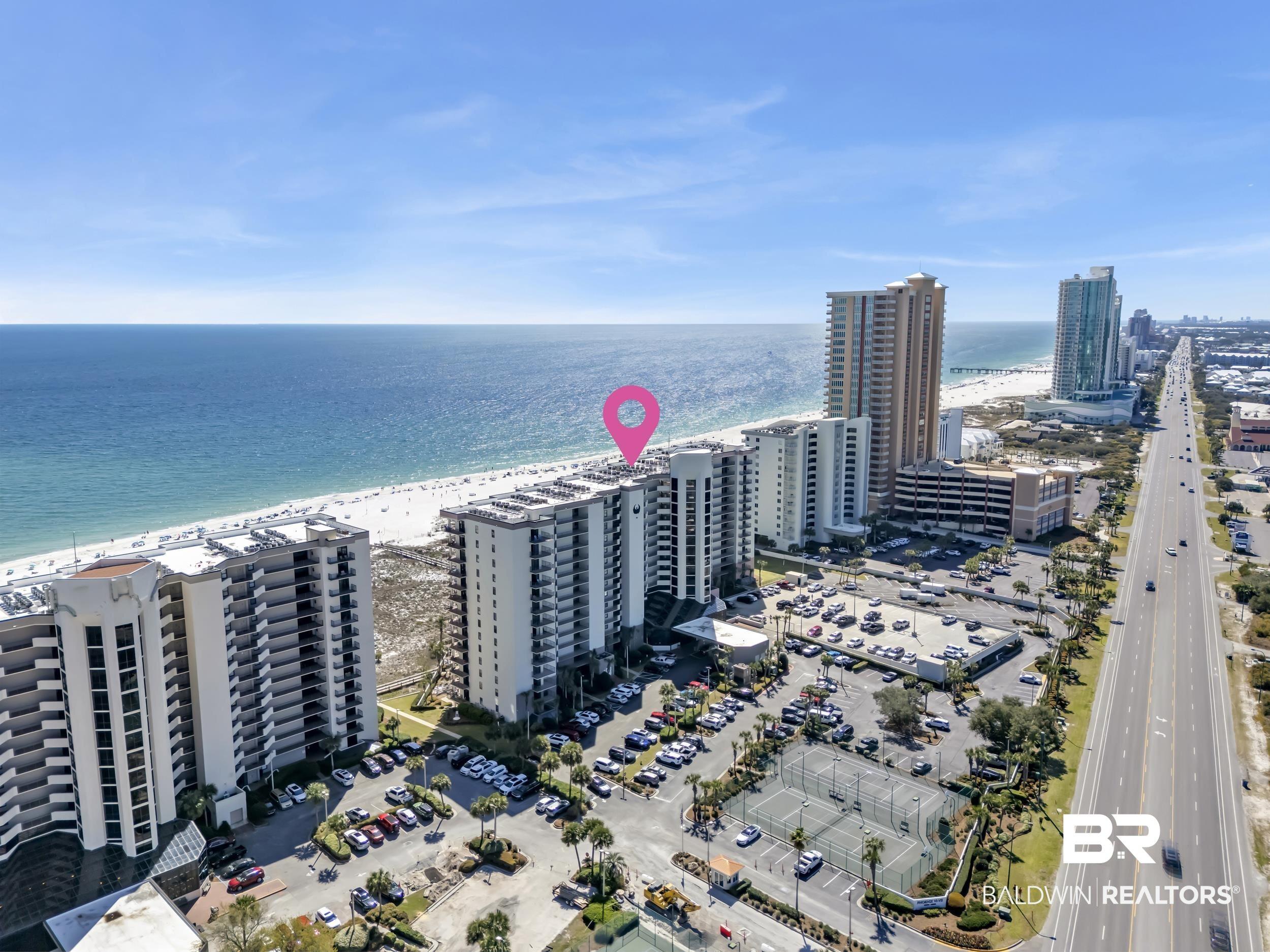 Image 4: View of urban area featuring waterfront with a beach and apartment complex / building