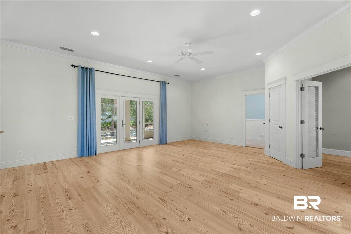 Image 3: Spacious room featuring wood-finish flooring, recessed lighting, and a ceiling fan