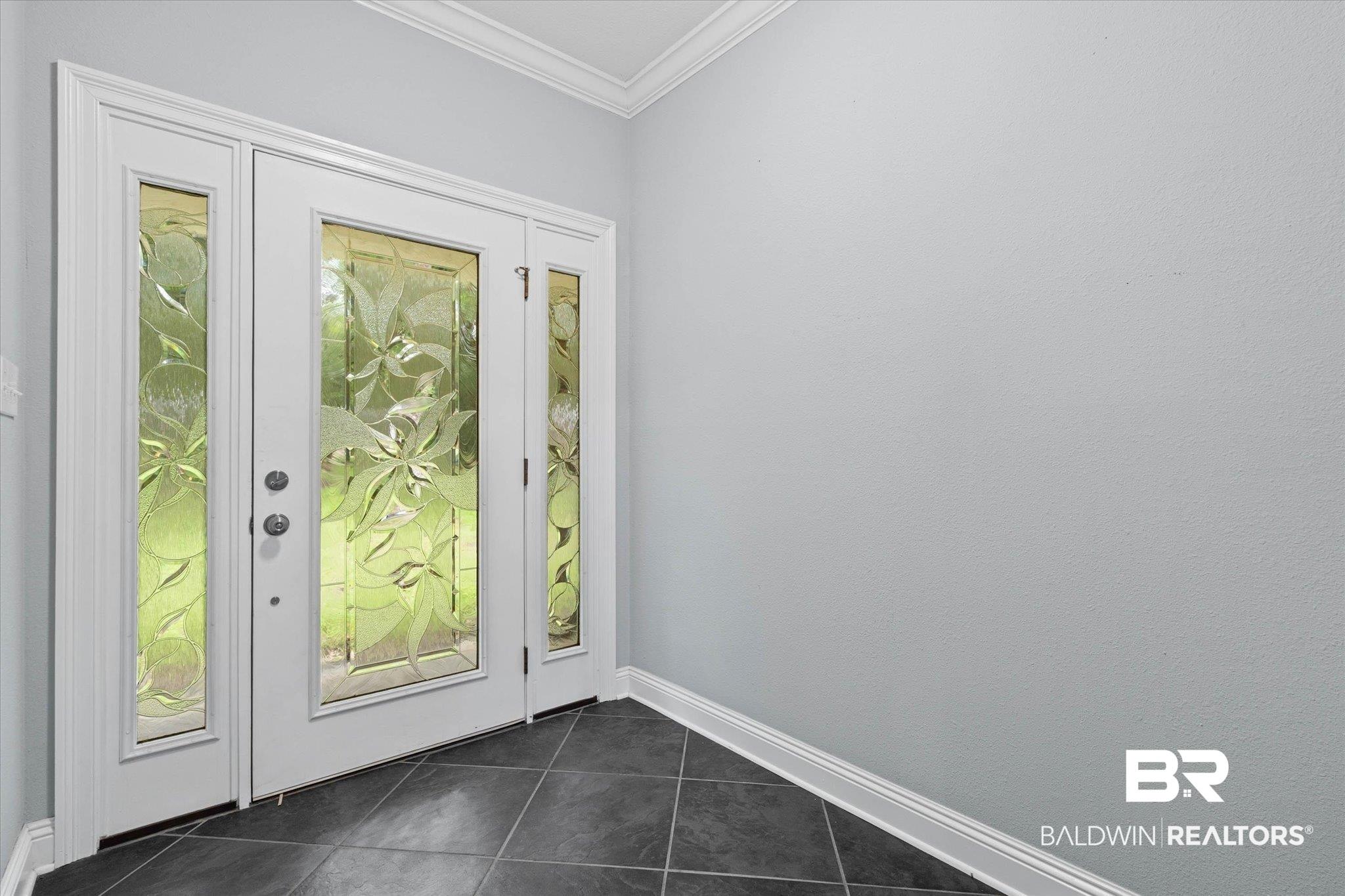 Image 2: Entryway featuring a double door with decorative glass inserts and two sidelights