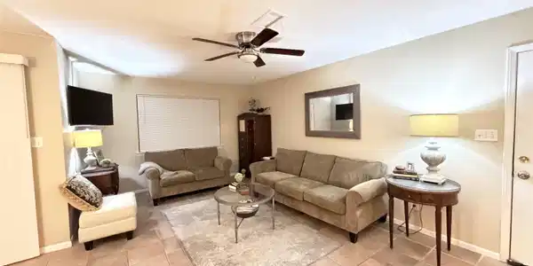 Image 2: Living area with ceiling fan, a textured ceiling, and light tile patterned floors