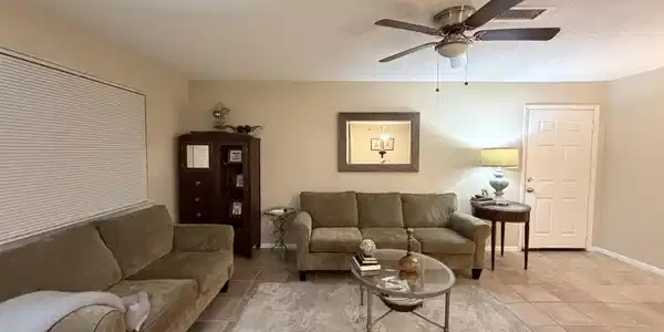 Image 4: Living area with light tile patterned floors, ceiling fan, and a textured ceiling