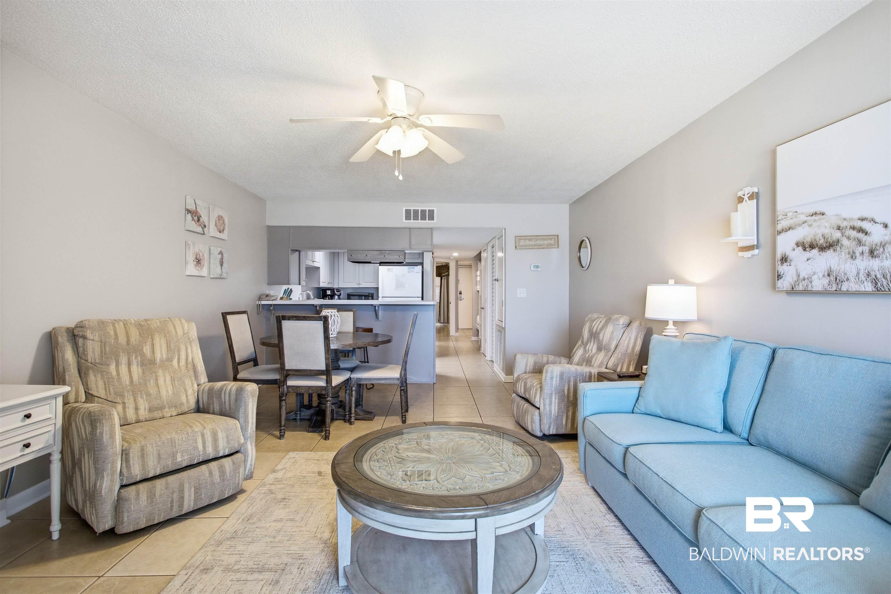 Image 3: Open-concept living space with tile flooring, a ceiling fan, and recessed lighting