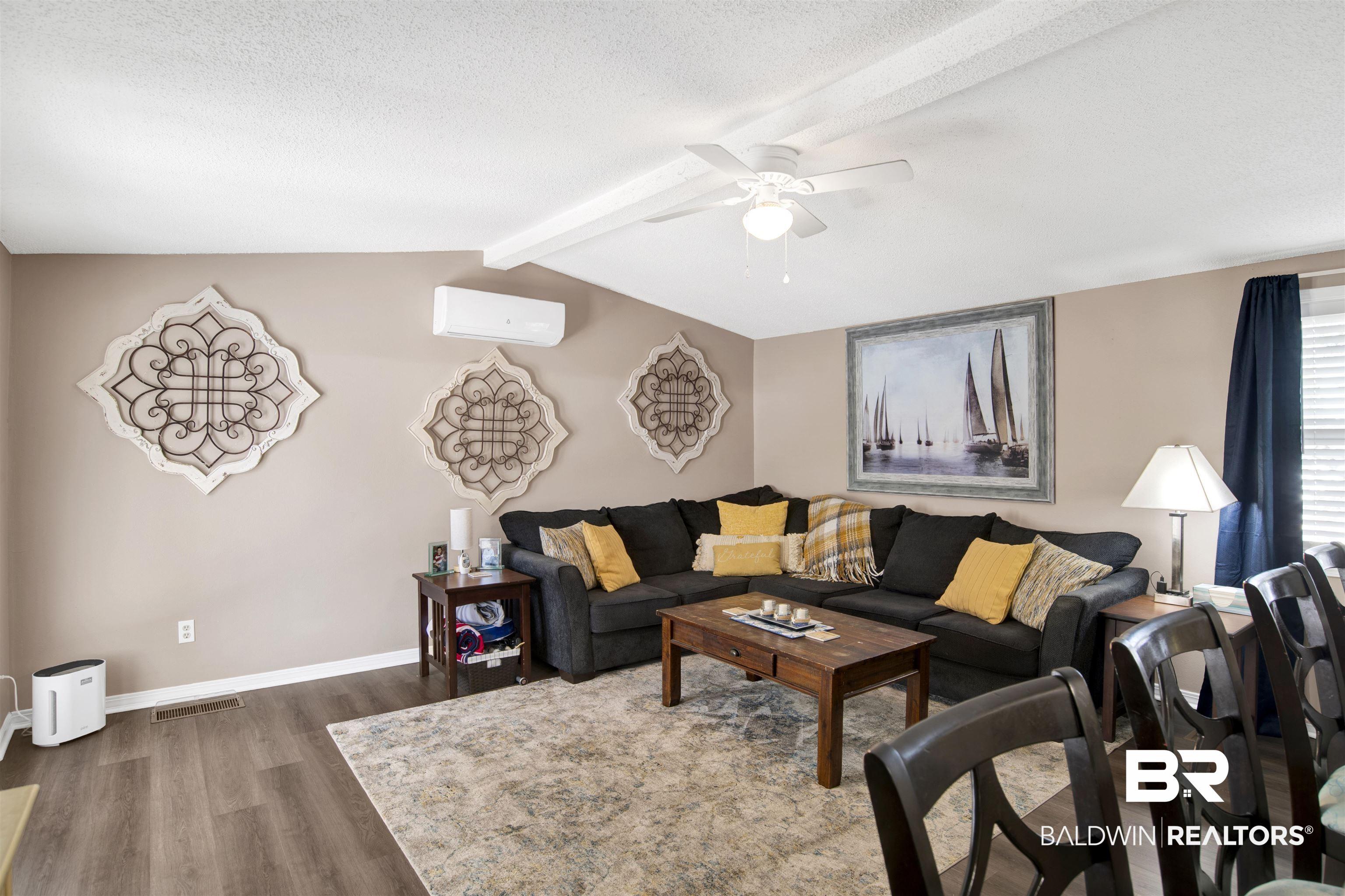 Image 3: Living room with wood finished floors, ceiling fan, and a textured ceiling