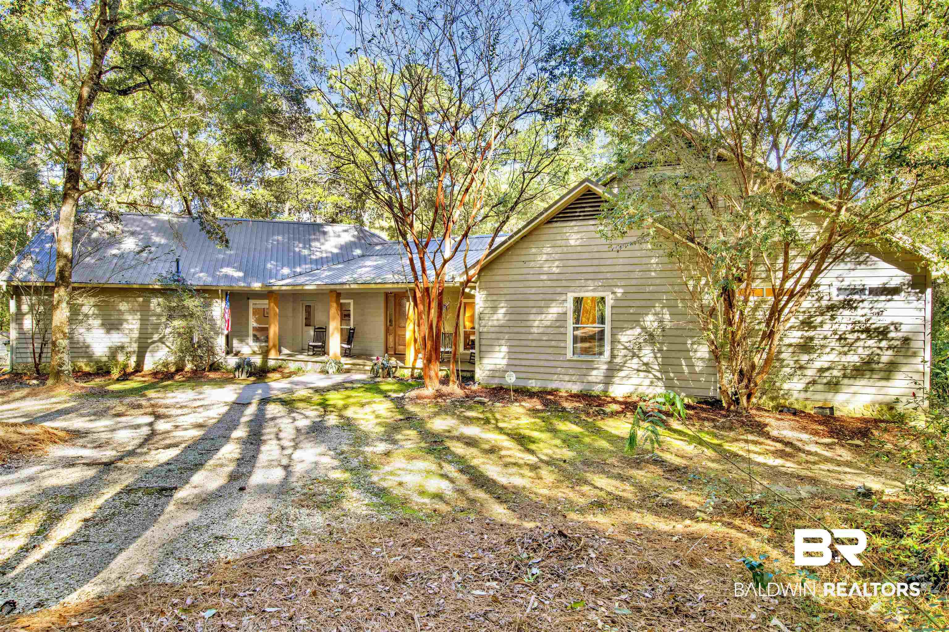 Image 2: Back of property with covered porch and a metal roof