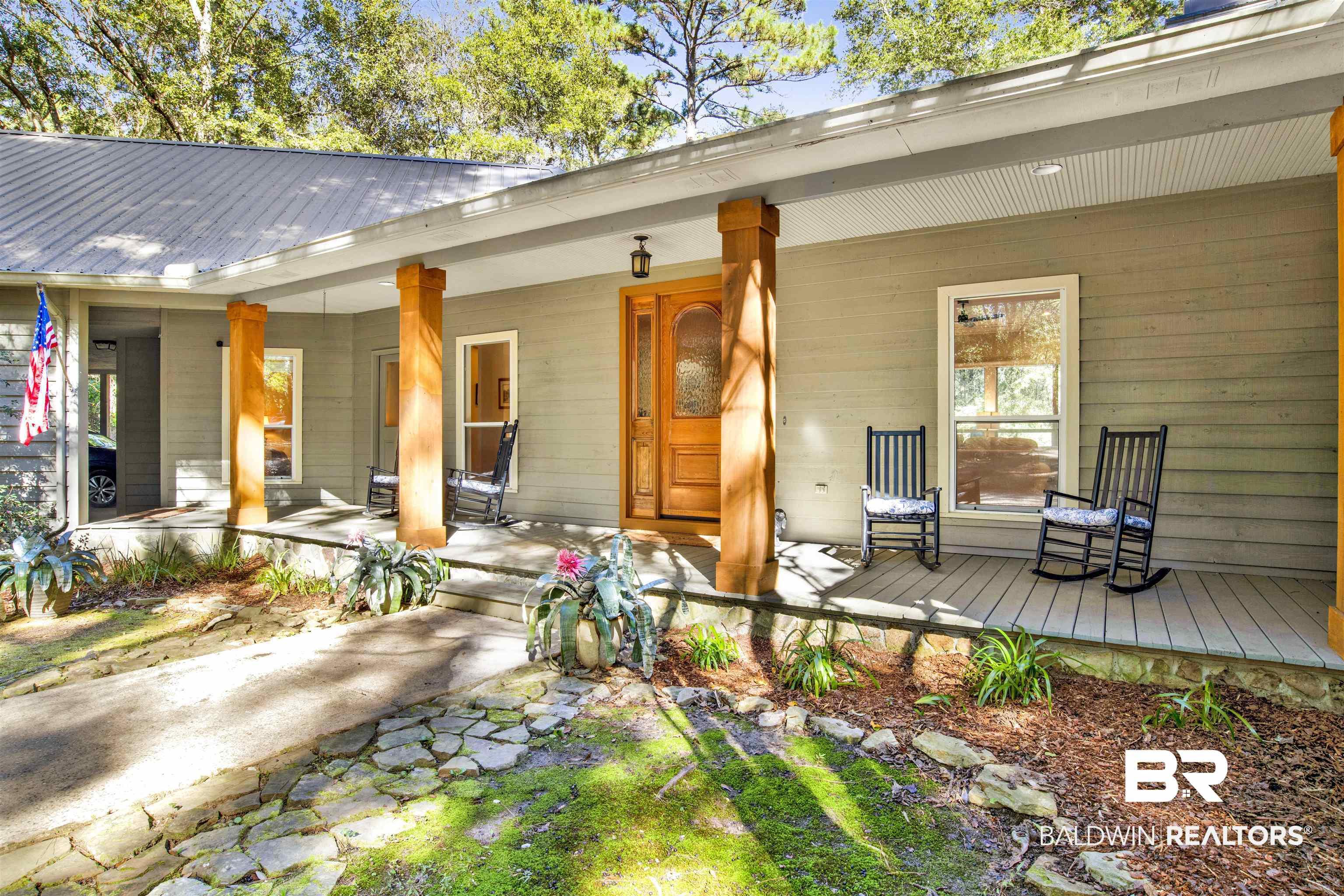 Image 4: Entrance to property featuring a porch and a metal roof