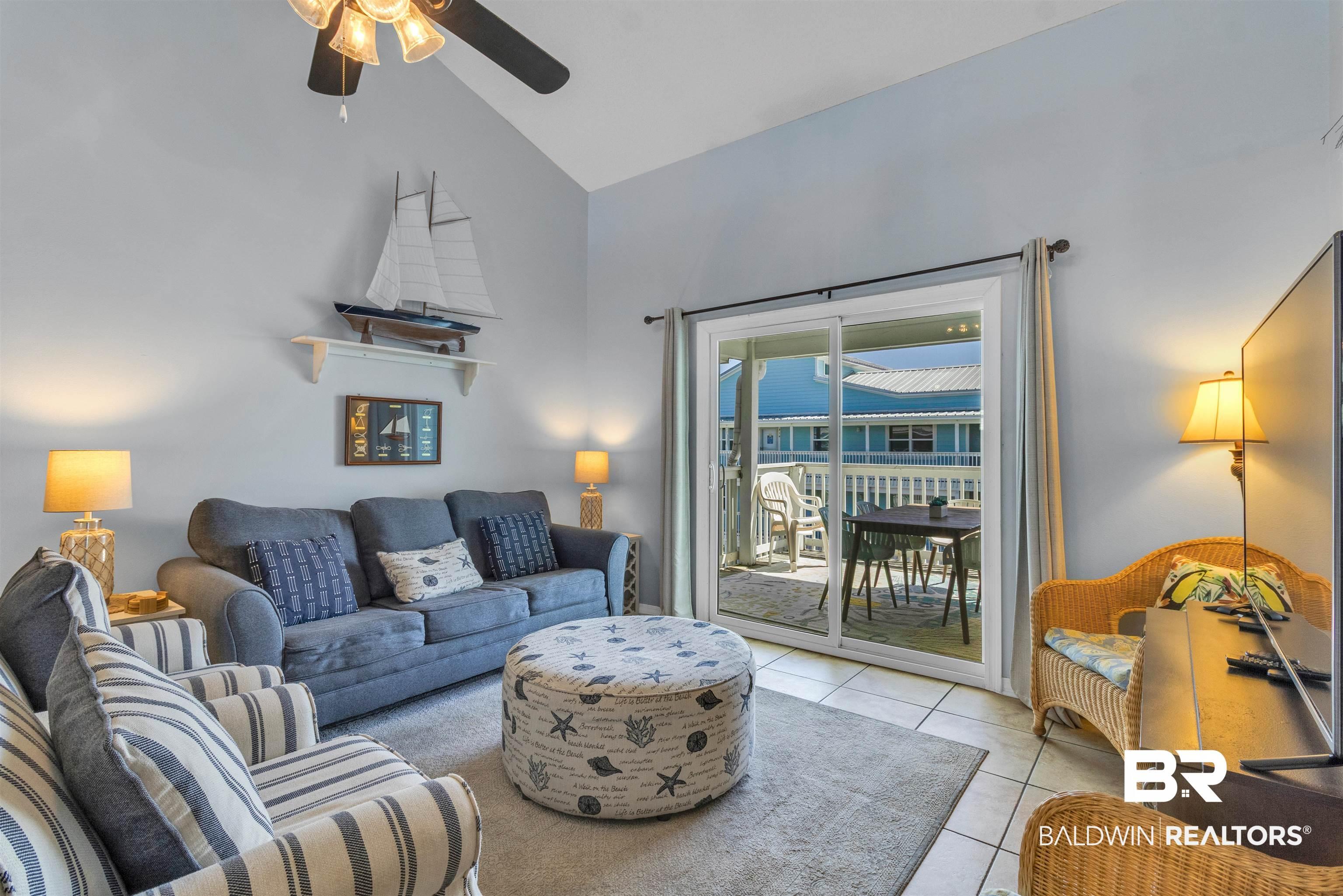 Image 3: Living room featuring lofted ceiling, light tile patterned flooring, and a ceiling fan