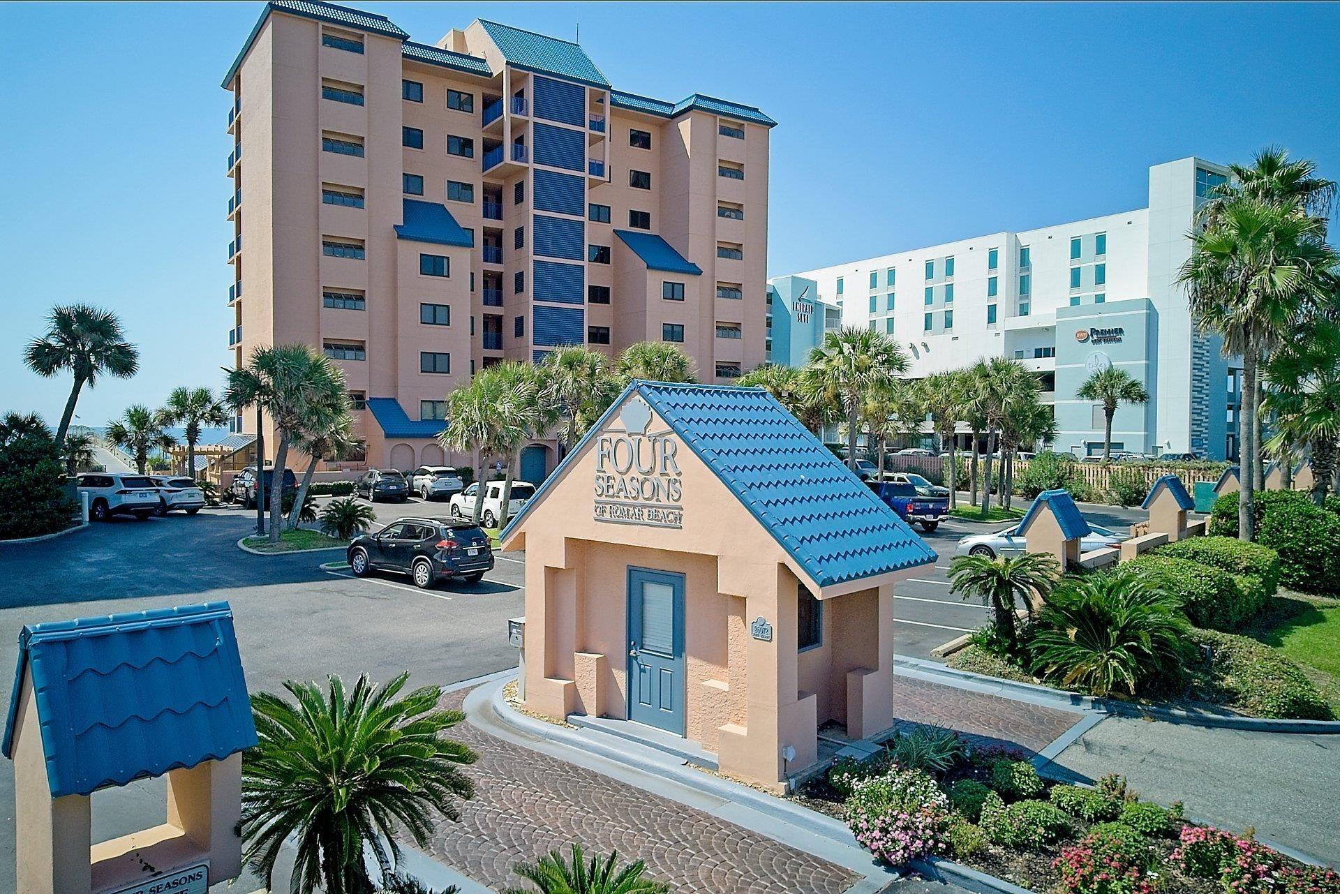 Image 1: View of building exterior with uncovered parking