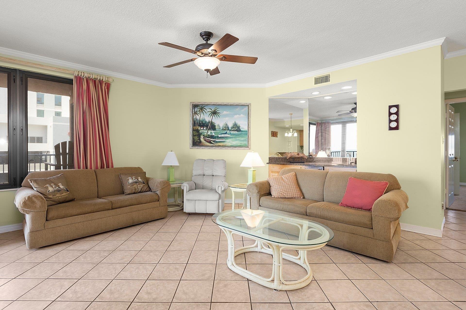 Image 3: Living room with light tile patterned floors, crown molding, a textured ceiling, and a ceiling fan