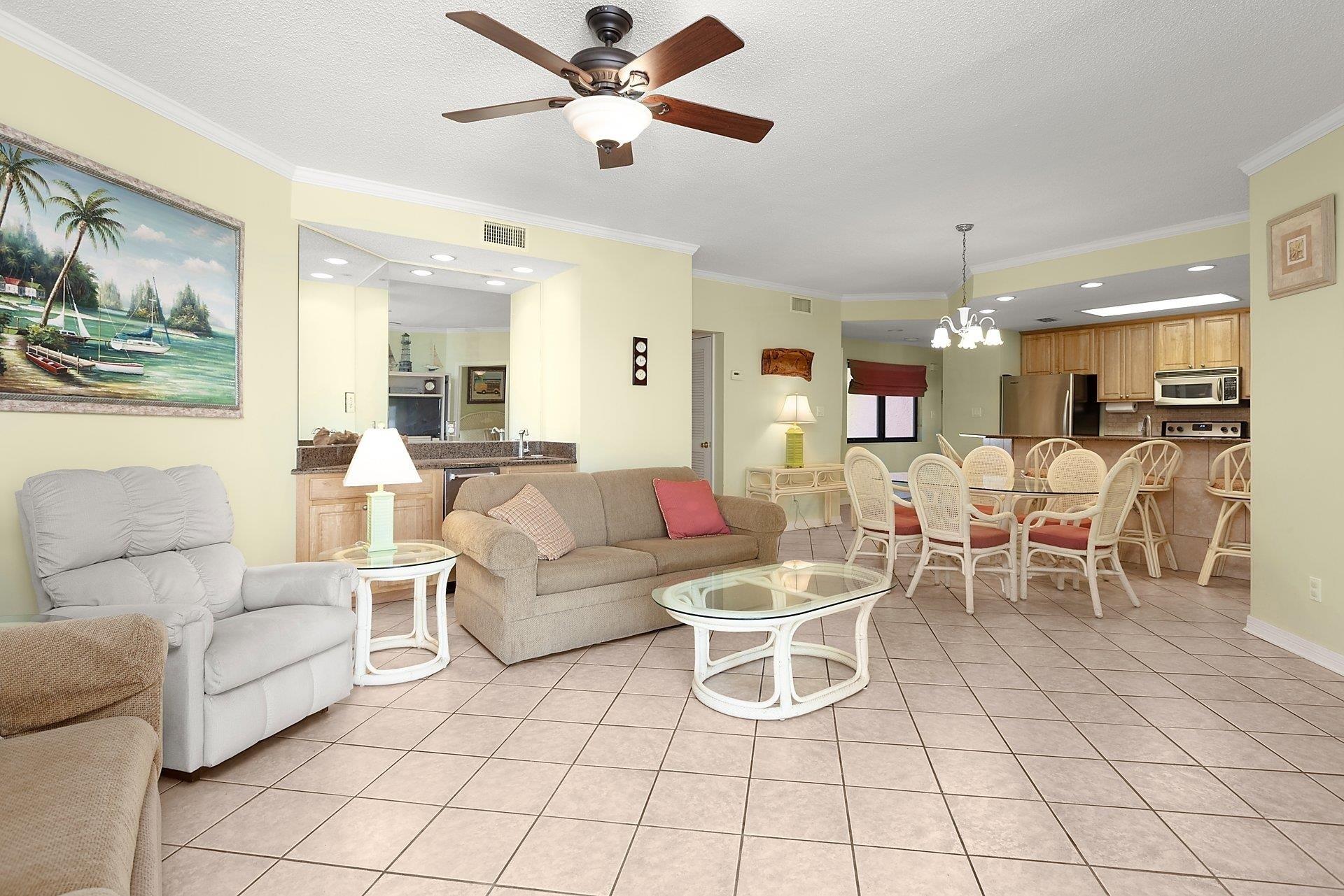 Image 4: Living room with ornamental molding, a chandelier, light tile patterned floors, ceiling fan, and recessed lighting
