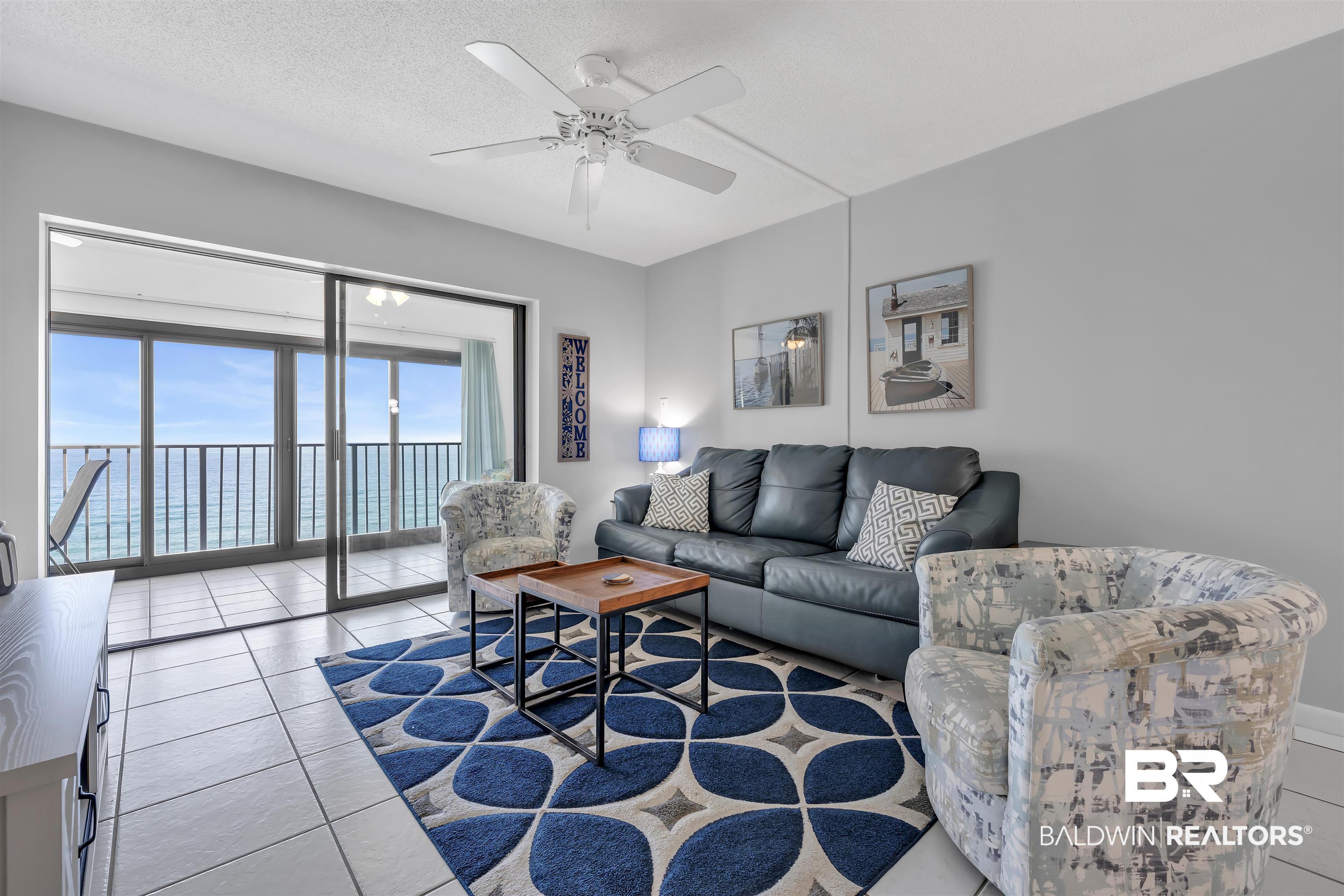 Image 2: Living area featuring ceiling fan and light tile patterned floors