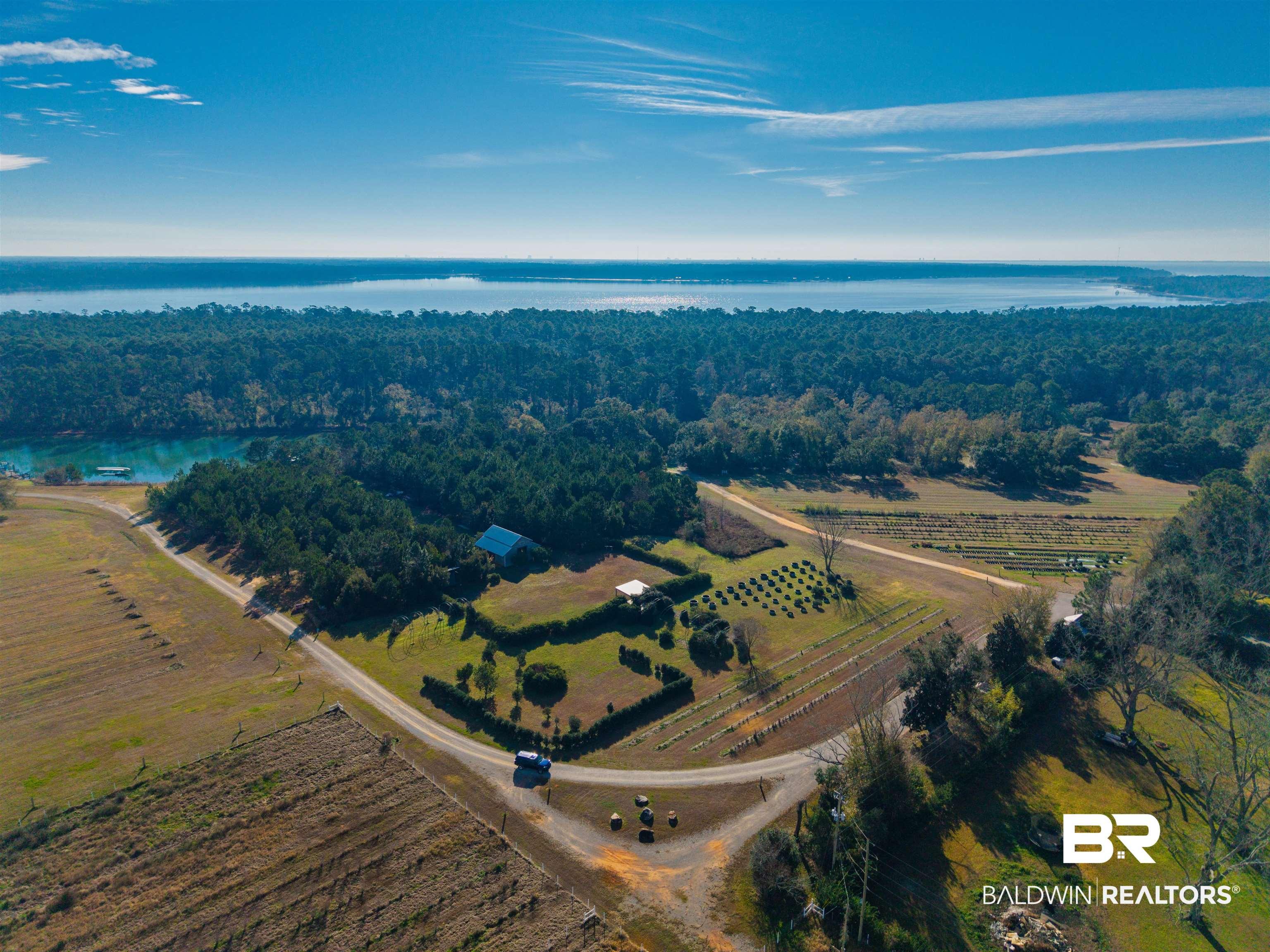 Image 1: Aerial view of property's location with a nearby body of water and rural landscape