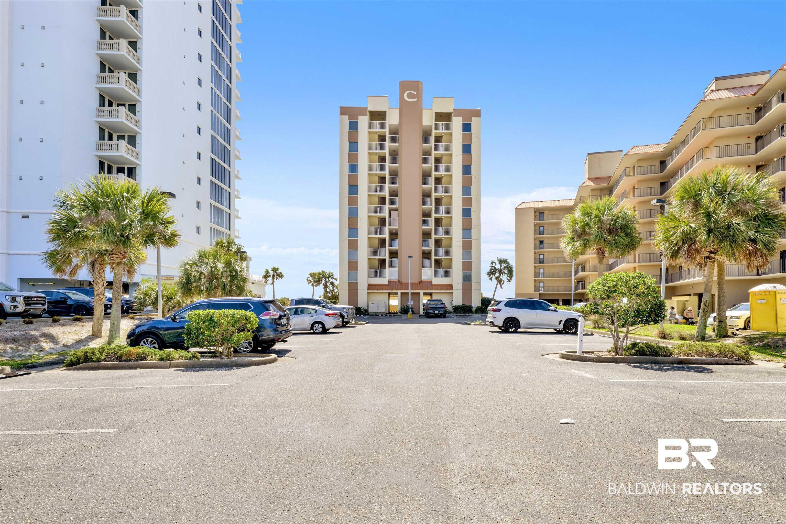Image 2: View of apartment building / complex with uncovered parking
