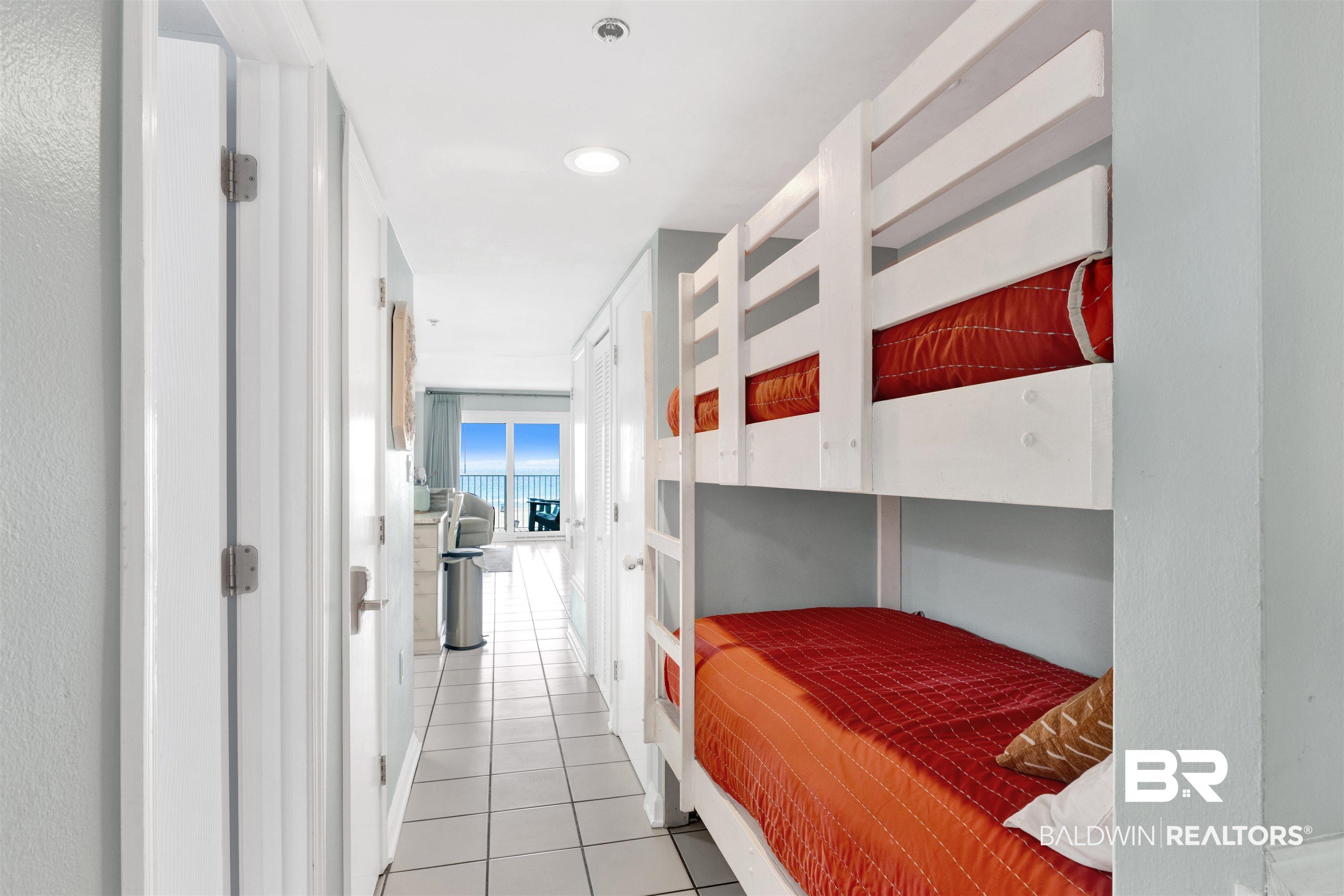 Image 3: Bedroom with light tile patterned floors