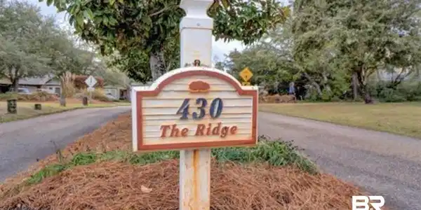 Image 3: Property identifier sign featuring "430 The Ridge" on a decorative post
