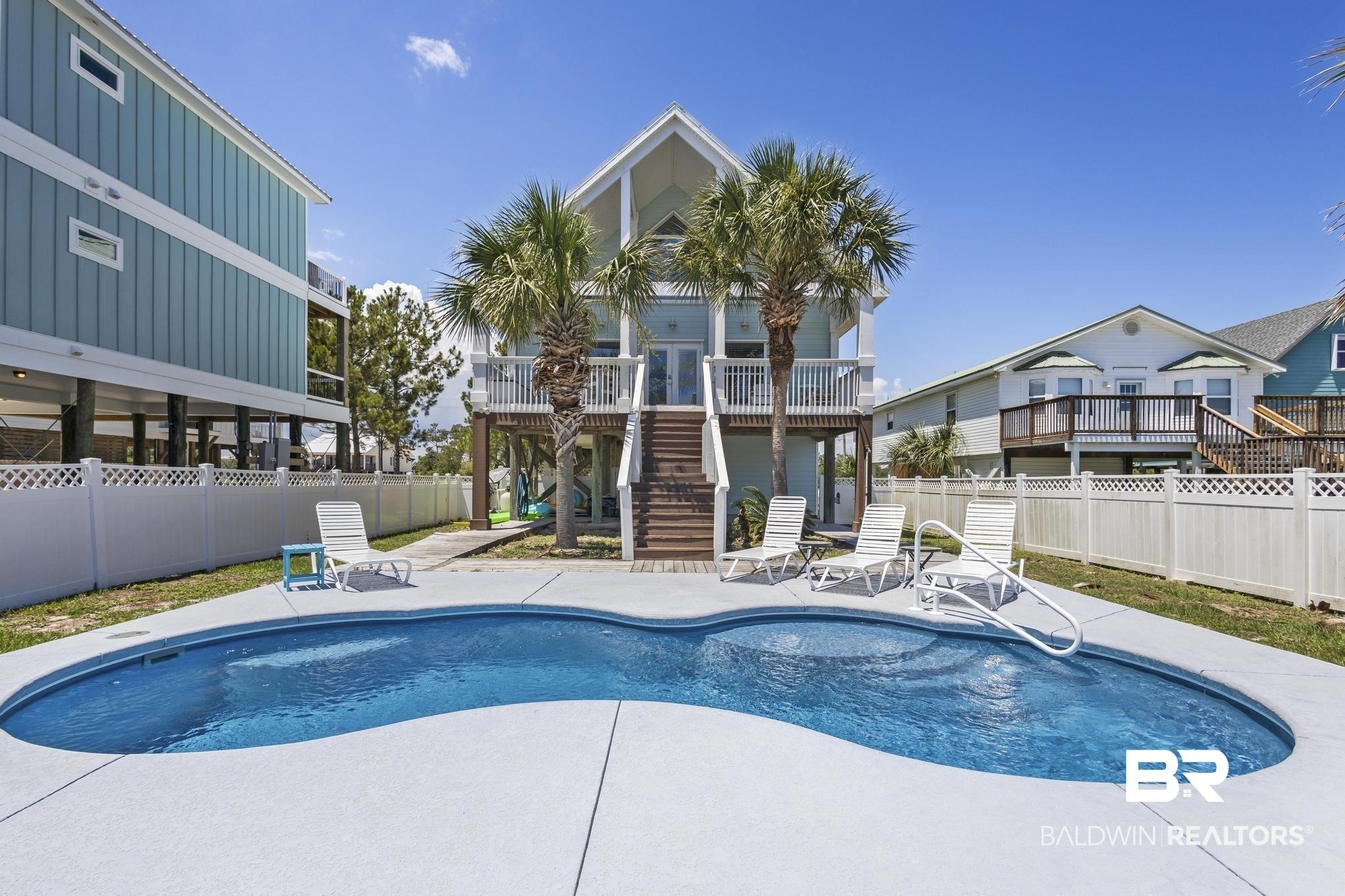 Image 2: View of pool featuring patio surround and a deck