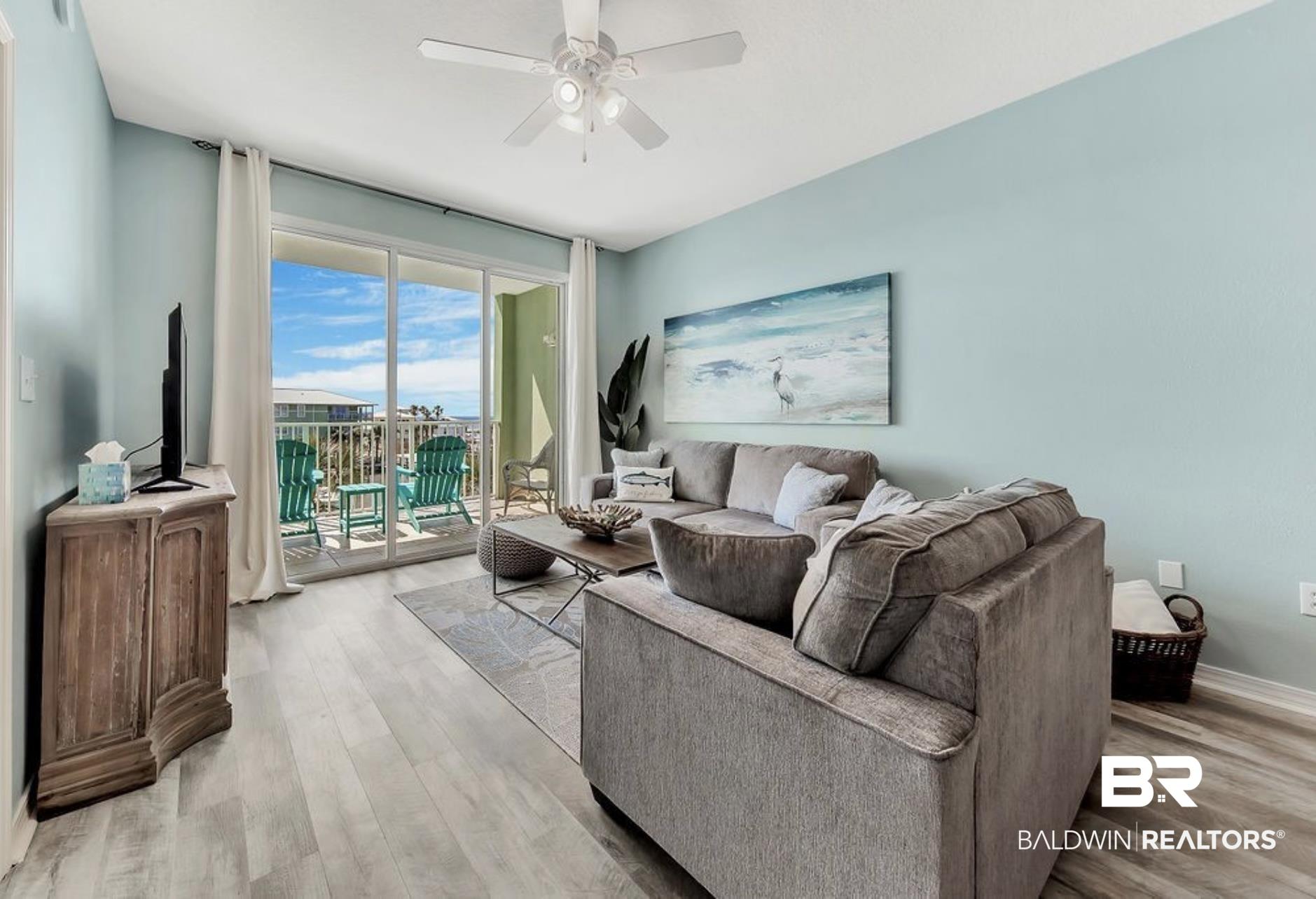 Image 2: Living room with light hardwood / wood-style floors and ceiling fan