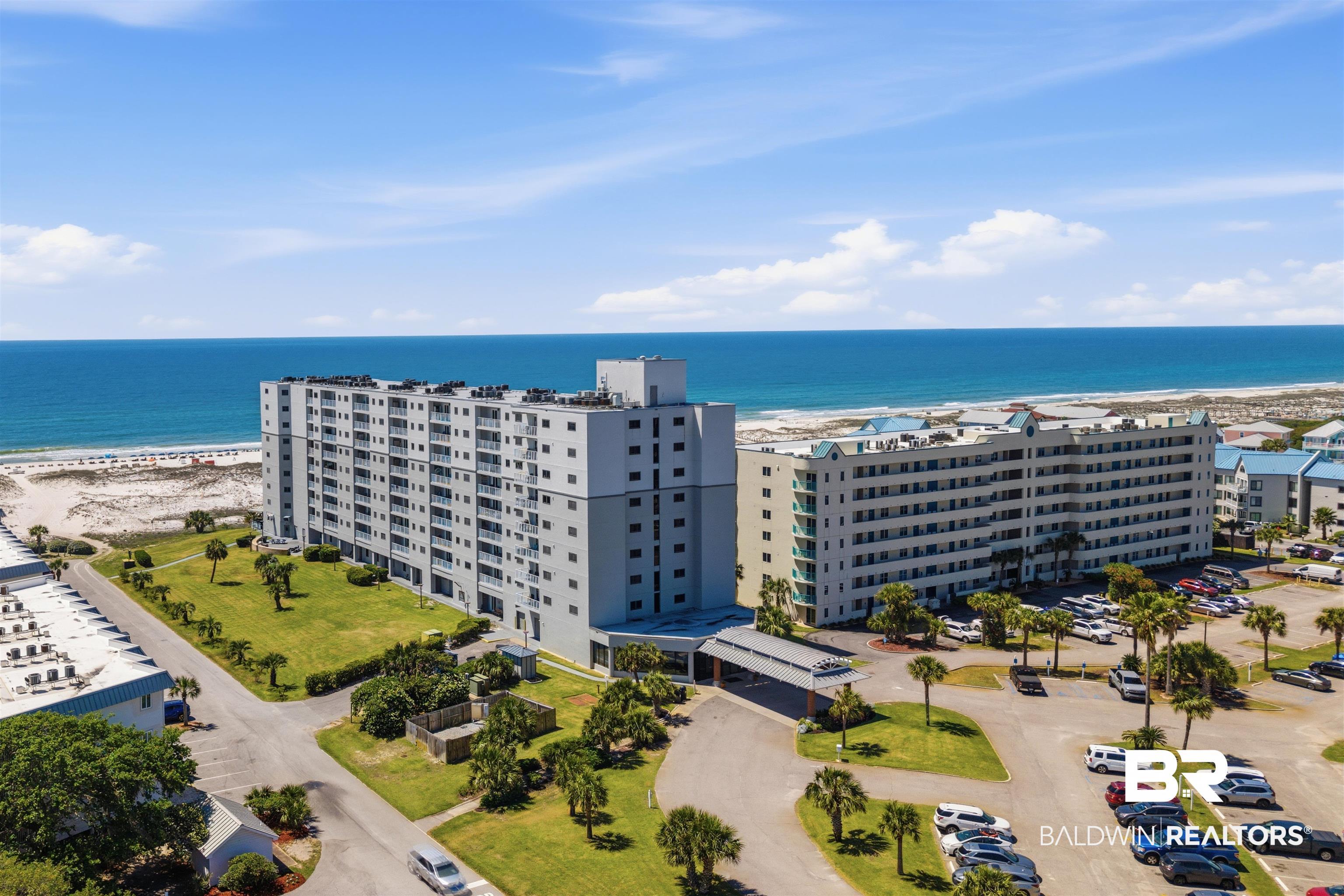 Image 3: Aerial view of apartment complex and expansive beach