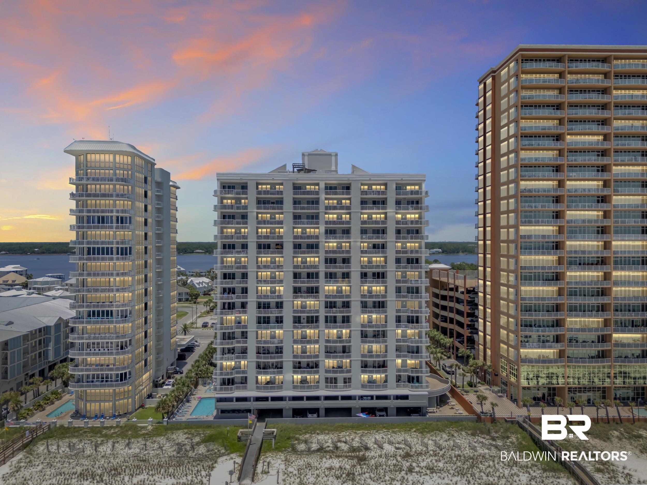 Image 2: Beachfront high-rise building featuring multiple private balconies with glass railings