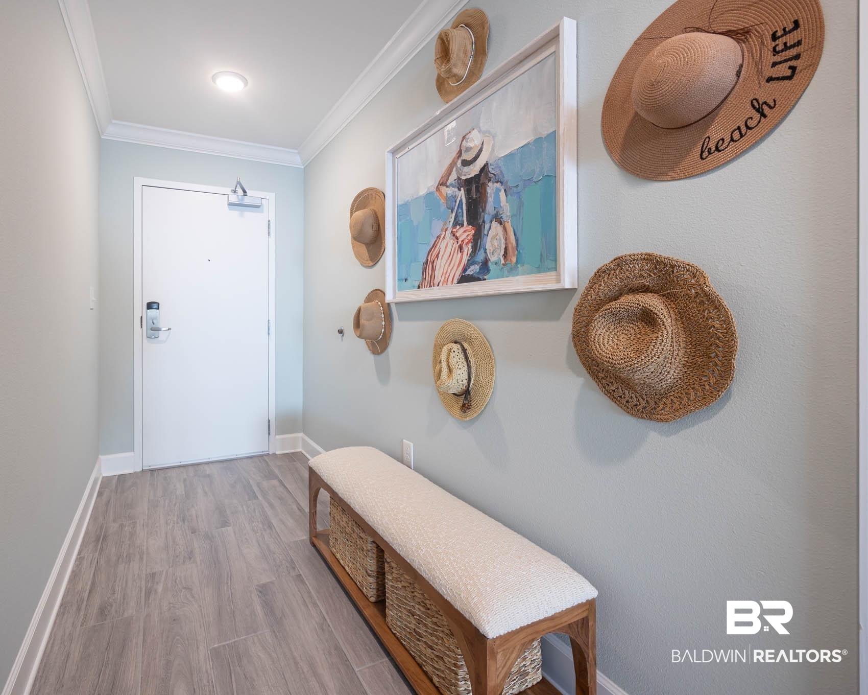 Image 2: Entryway featuring wood finished floors and ornamental molding