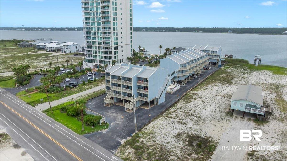 Image 2: Multi-story residential buildings with balconies situated along a body of water