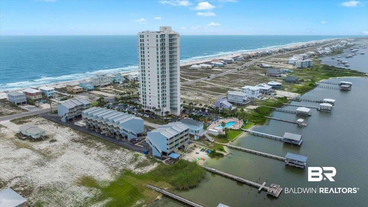 Image 3: Expansive coastal property featuring a multi-story tower building, a series of multi-unit structures, multiple private docks, and an outdoor swimming pool