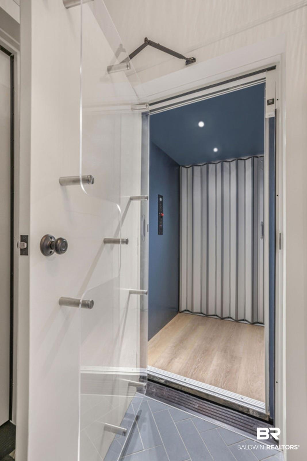 Image 3: Private residential elevator featuring wood-finish flooring, recessed lighting, and a deep blue ceiling