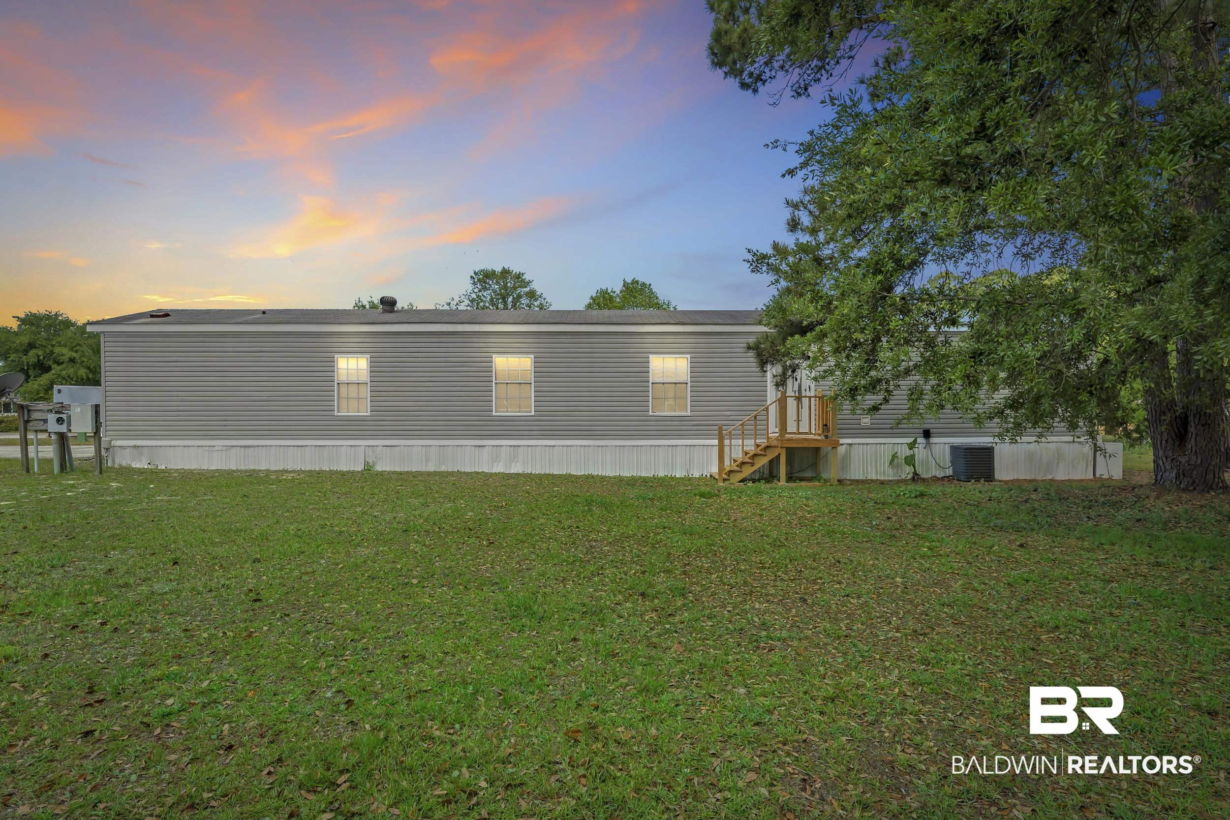 Image 2: Rear view of property with a yard