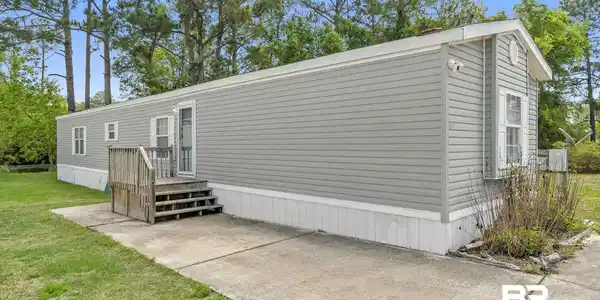 Image 3: Back of house featuring a lawn