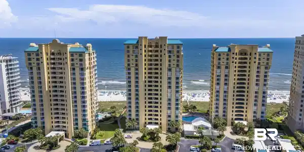 Image 2: Coastal high-rise buildings featuring private balconies and a resort-style pool area