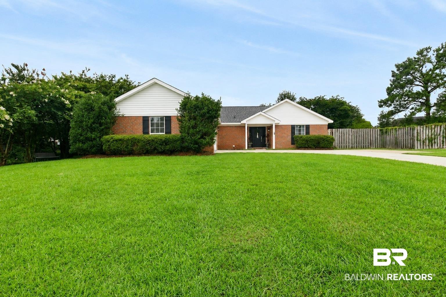Image 2: Brick exterior with white siding accents and black shutters