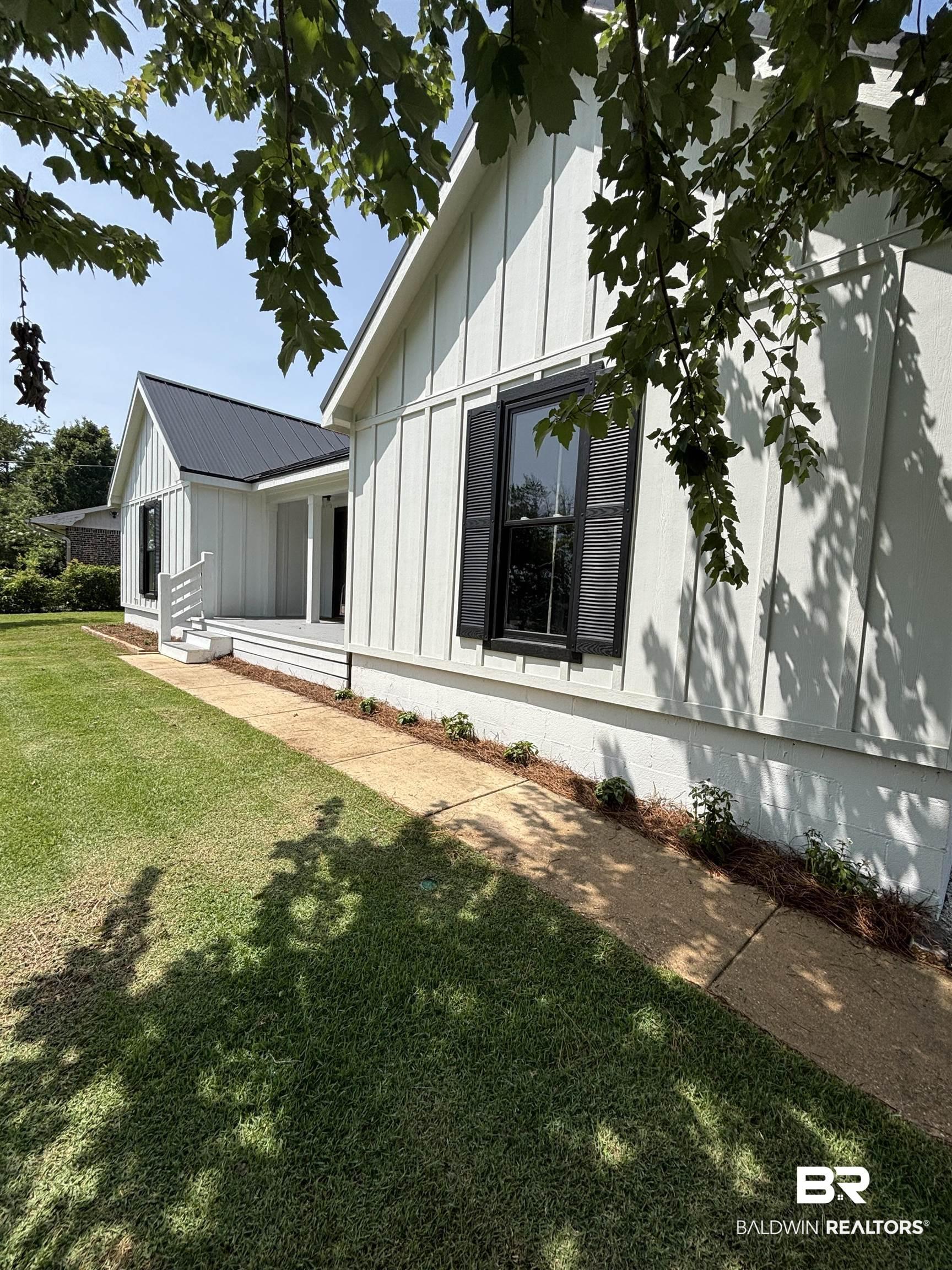 Image 2: White board and batten siding with contrasting black shutters