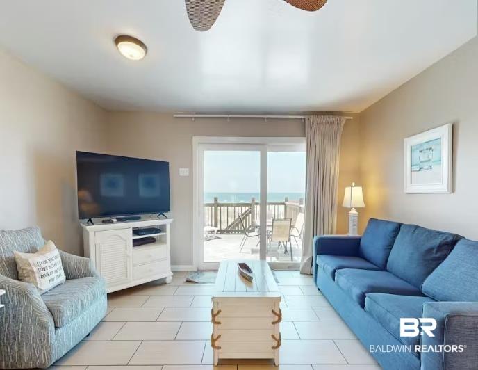 Image 3: Living room with ceiling fan and light tile patterned floors
