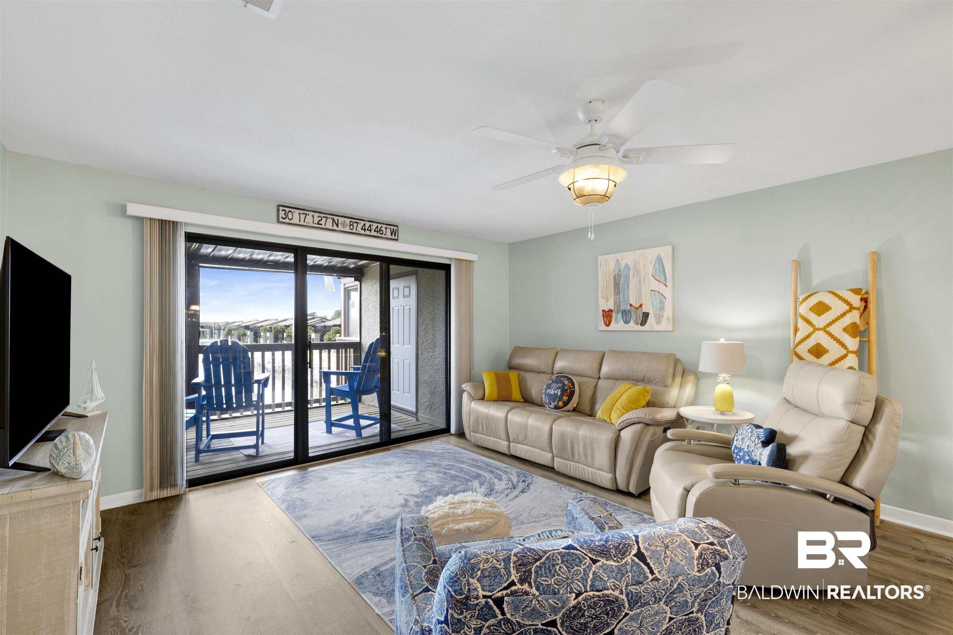 Image 3: Living area featuring sliding glass doors opening to an exterior balcony