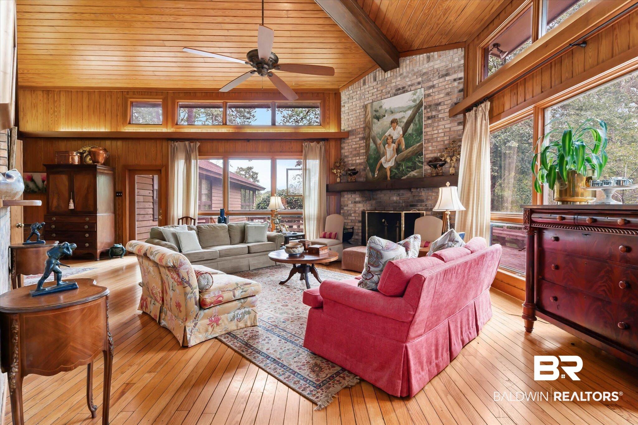 Image 3: Vaulted wood-paneled ceiling with exposed beam and ceiling fan