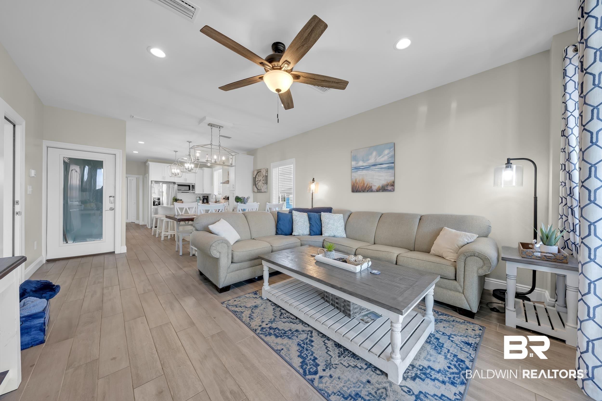 Image 2: Living area with recessed lighting, light wood finished floors, and a ceiling fan