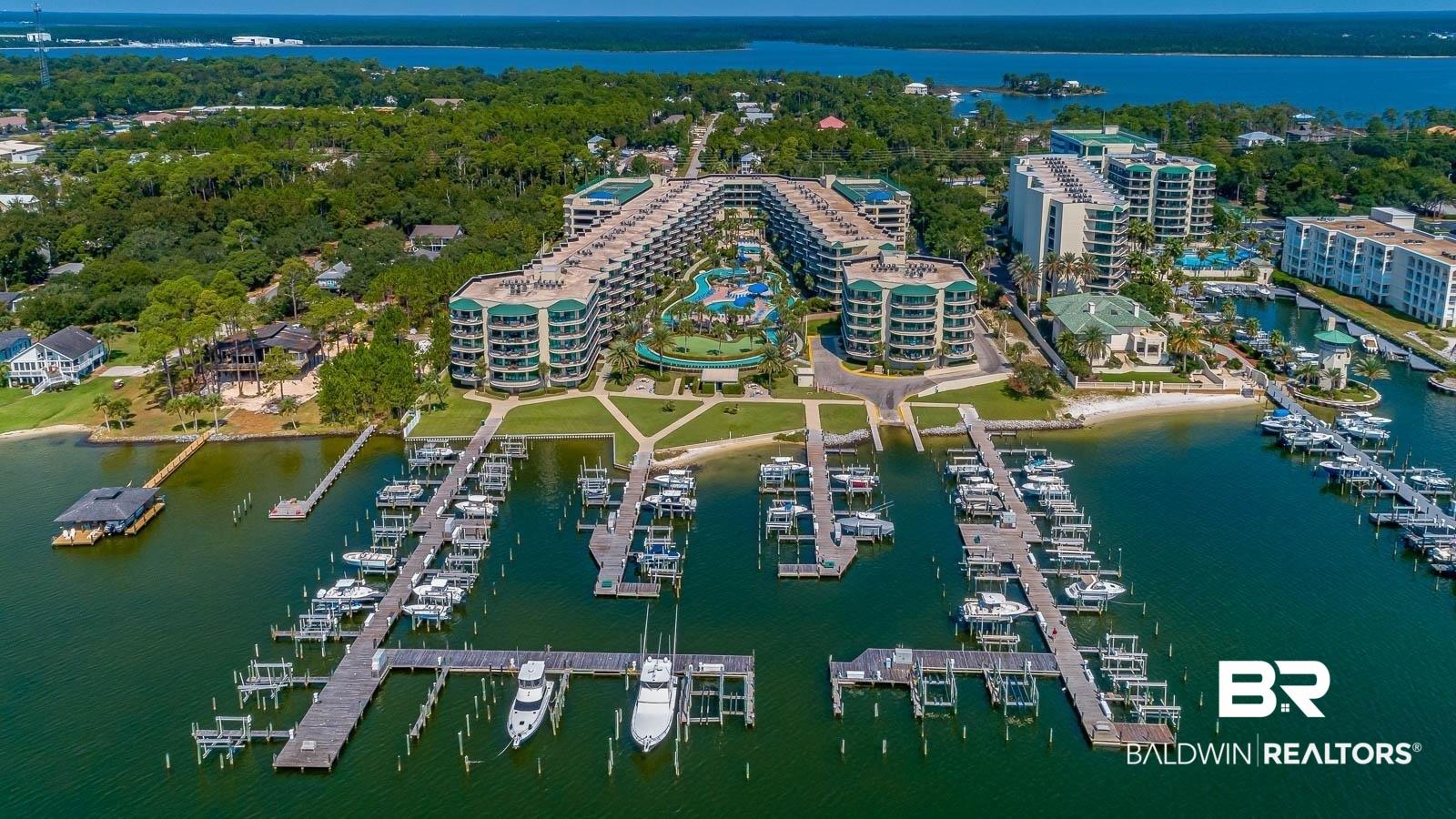 Image 1: Aerial view of property and surrounding area featuring a nearby body of water